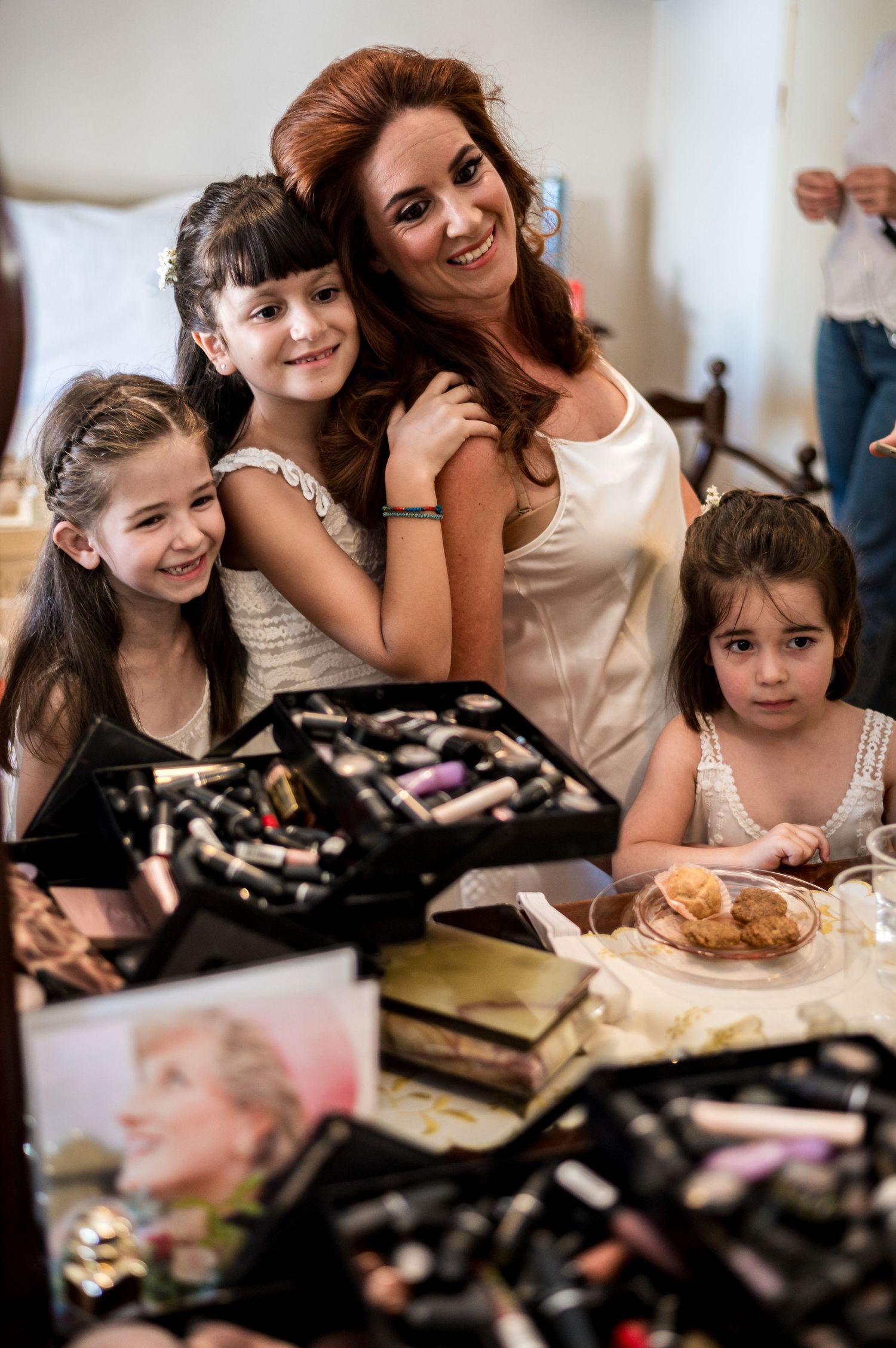 A joyful moment captured during wedding preparations with makeup supplies spread on the table.