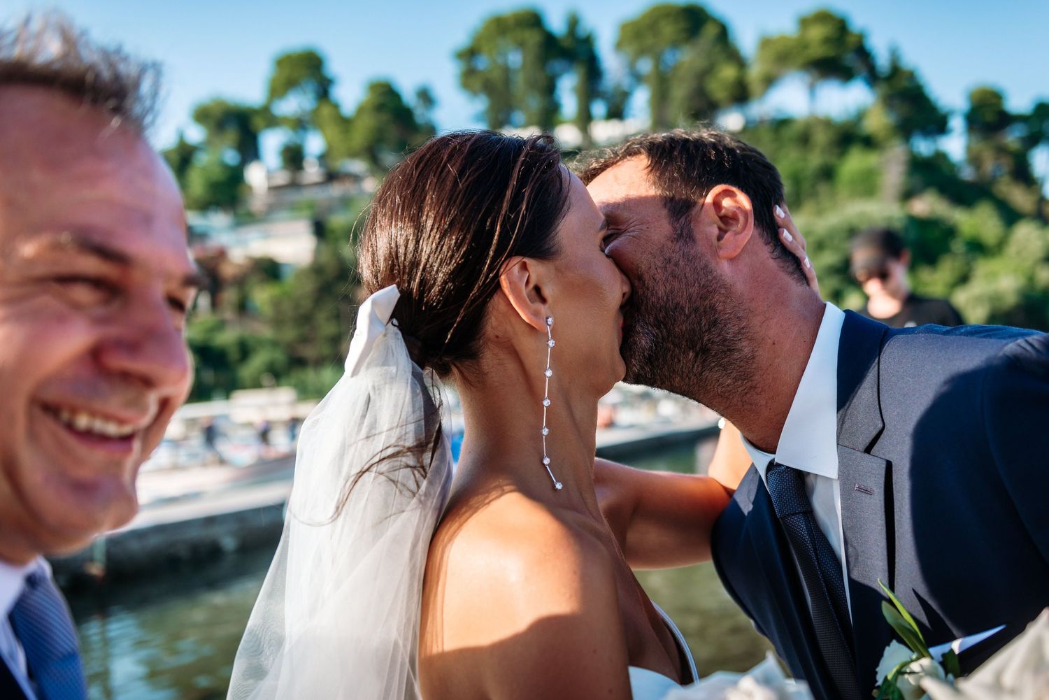 Joyful wedding celebration captured against a scenic coastal backdrop.