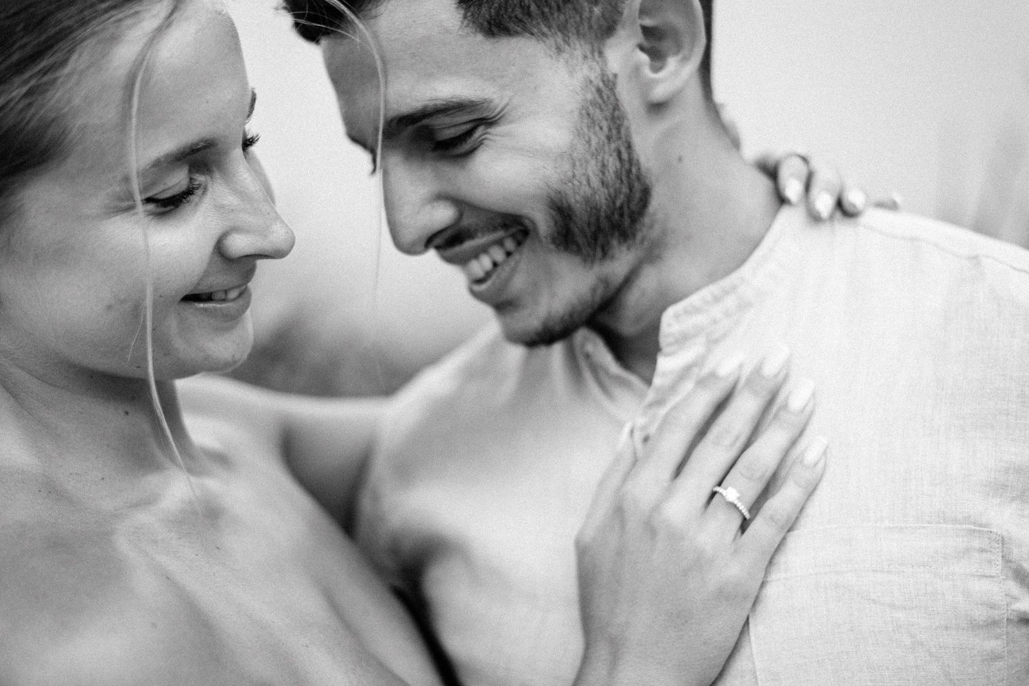 Intimate black and white portrait of a couple sharing tender moments together.