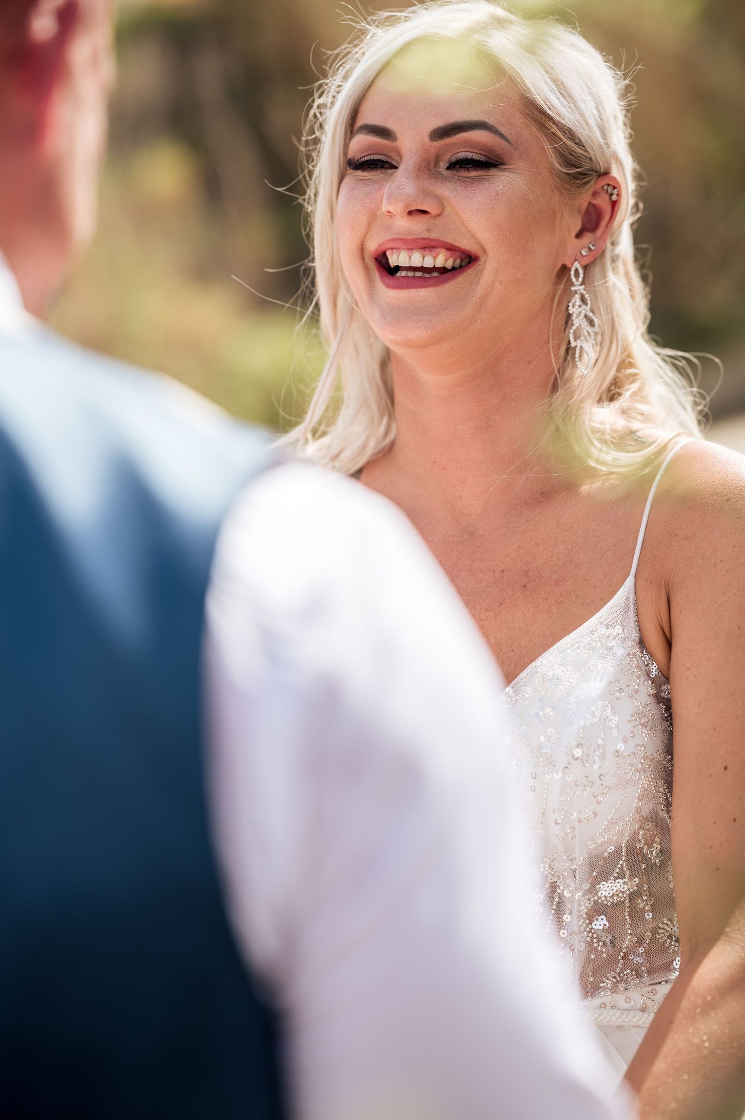Close-up shots of bride in lace wedding dress showing joyful expressions.