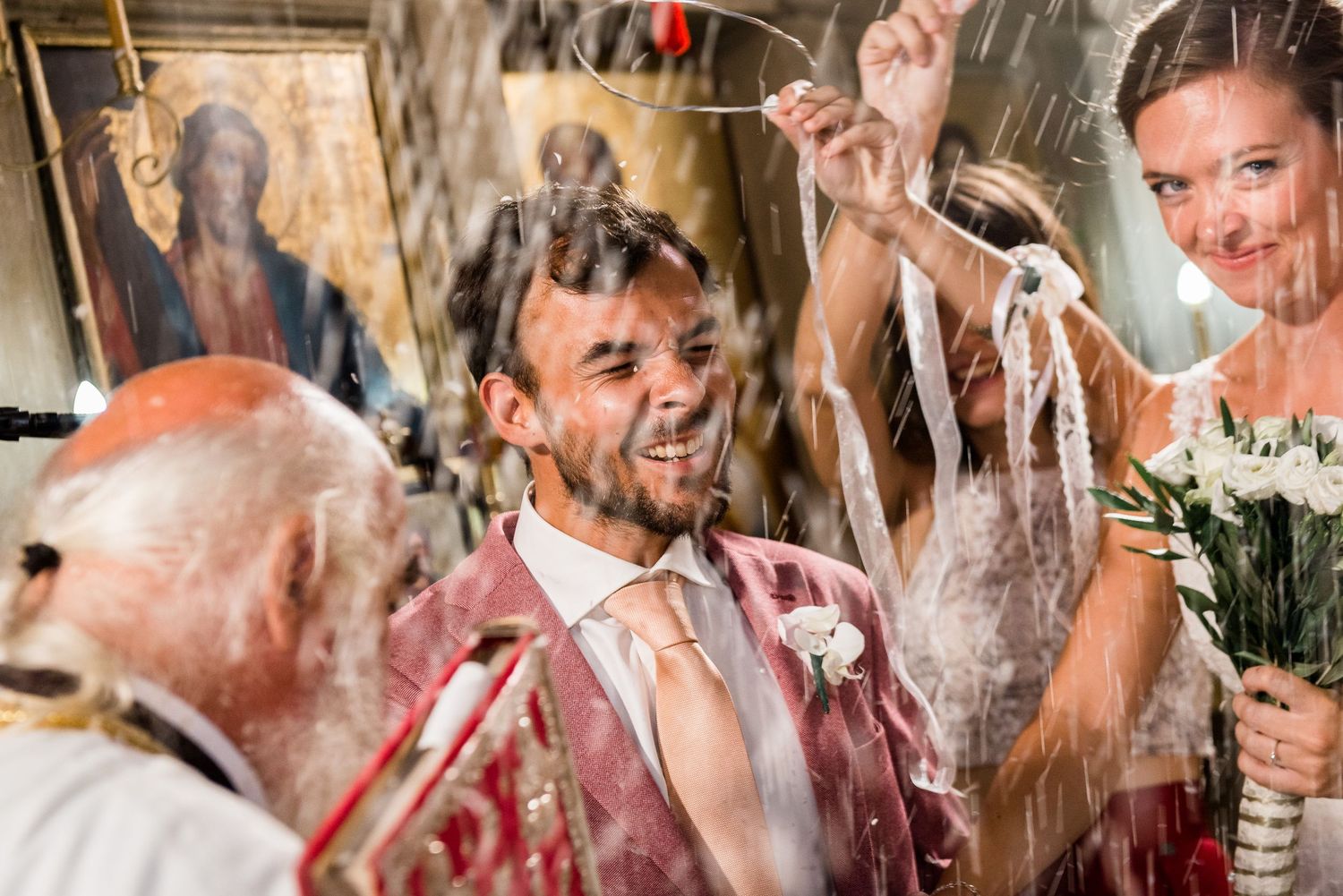 Celebratory moment at wedding reception with splashing drinks and laughter.