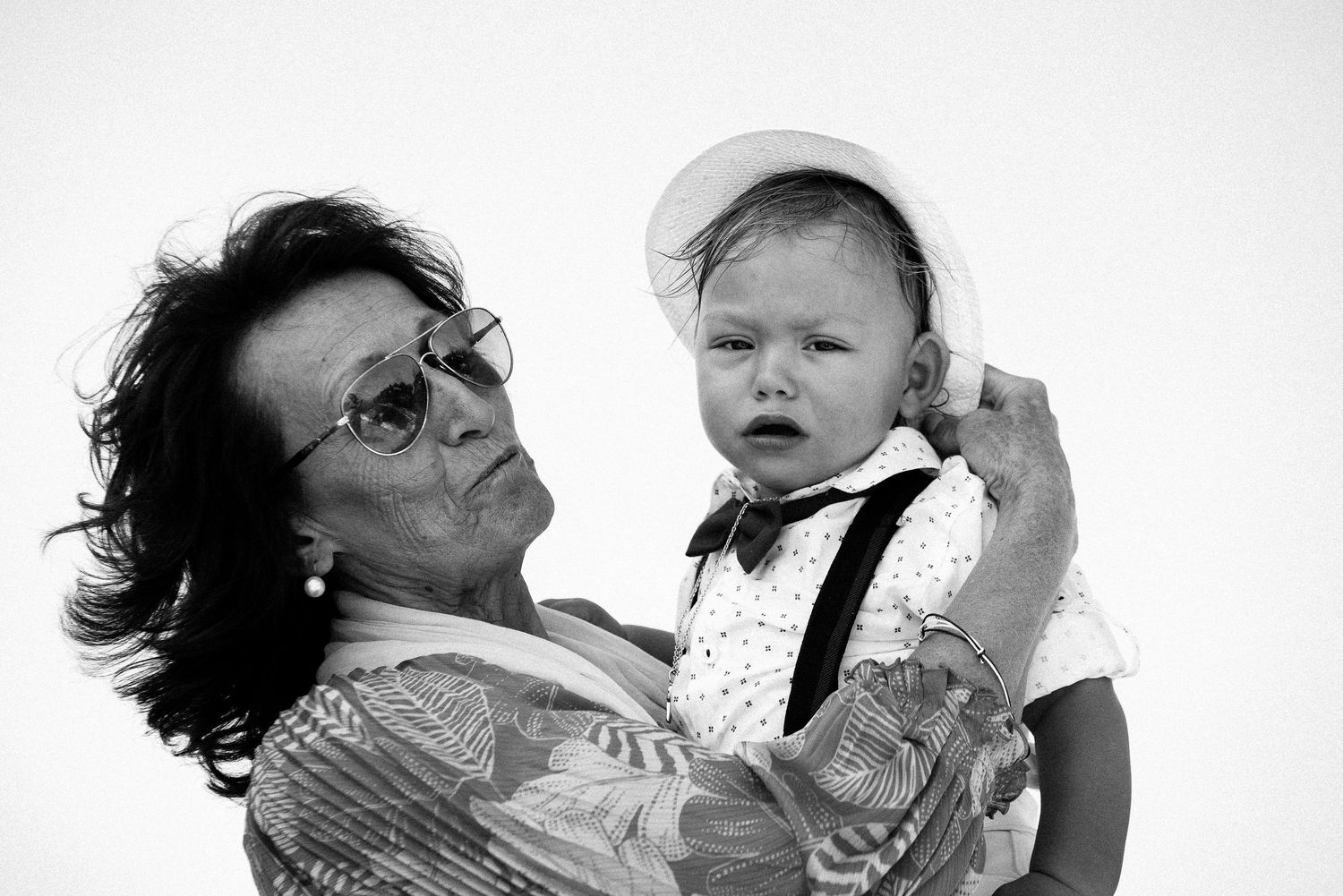 Black and white portrait showing tender moment between two people.