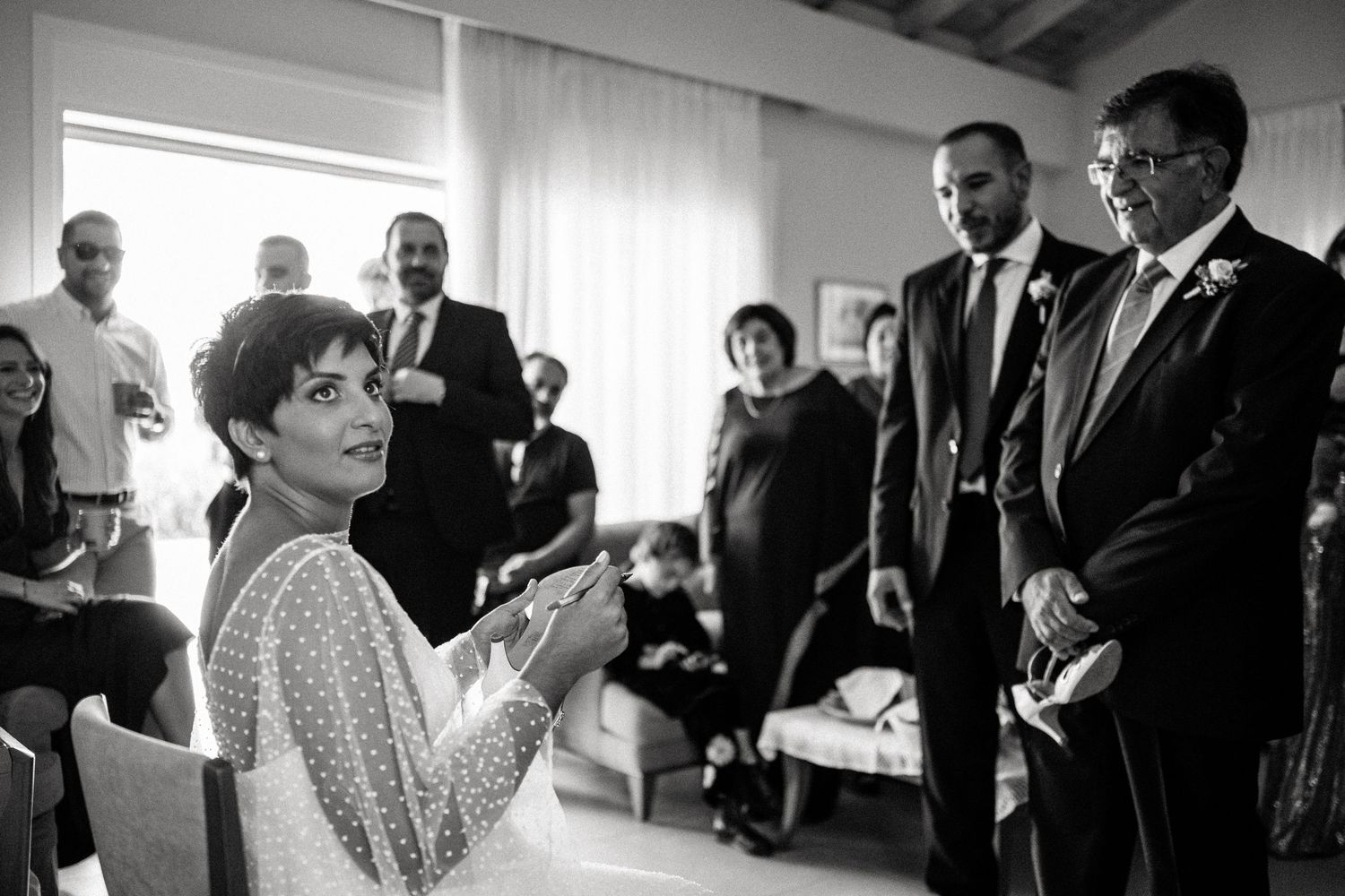 Black and white candid shots of wedding preparations with natural window light.