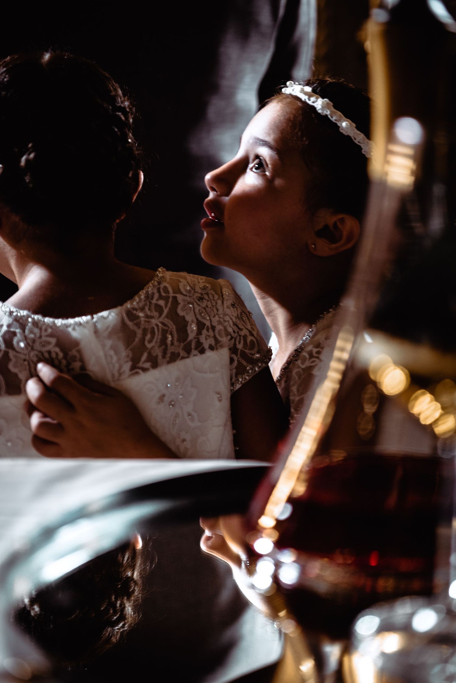 Artistic close-up shots of a bride in lace dress with dramatic lighting and bokeh effects.