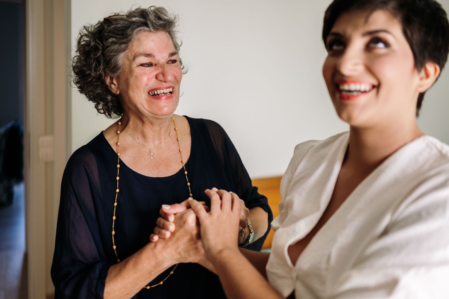 Two people sharing a joyful moment while getting ready.