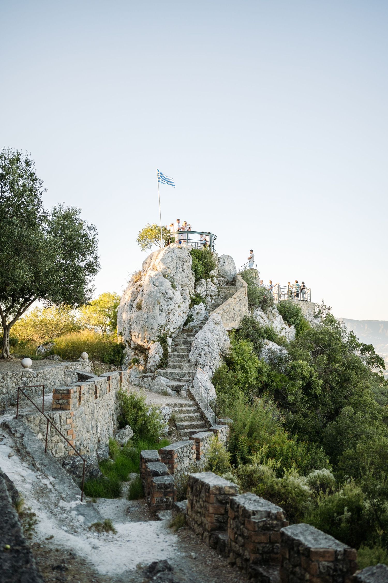 Ancient stone castle ruins with winding steps set against a clear blue sky.