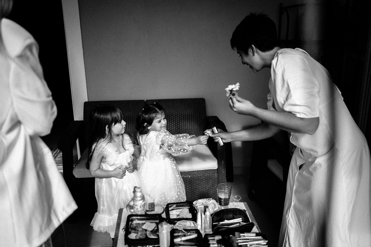 Black and white image showing preparation moments before a formal event.