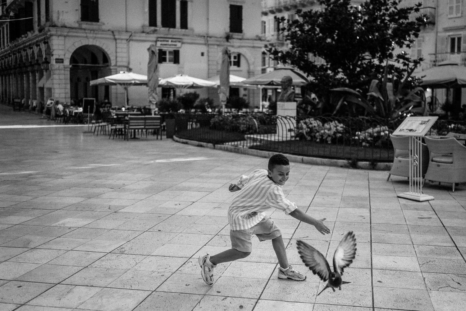 Series of black and white photos showing joyful running and playing in an ornate corridor.