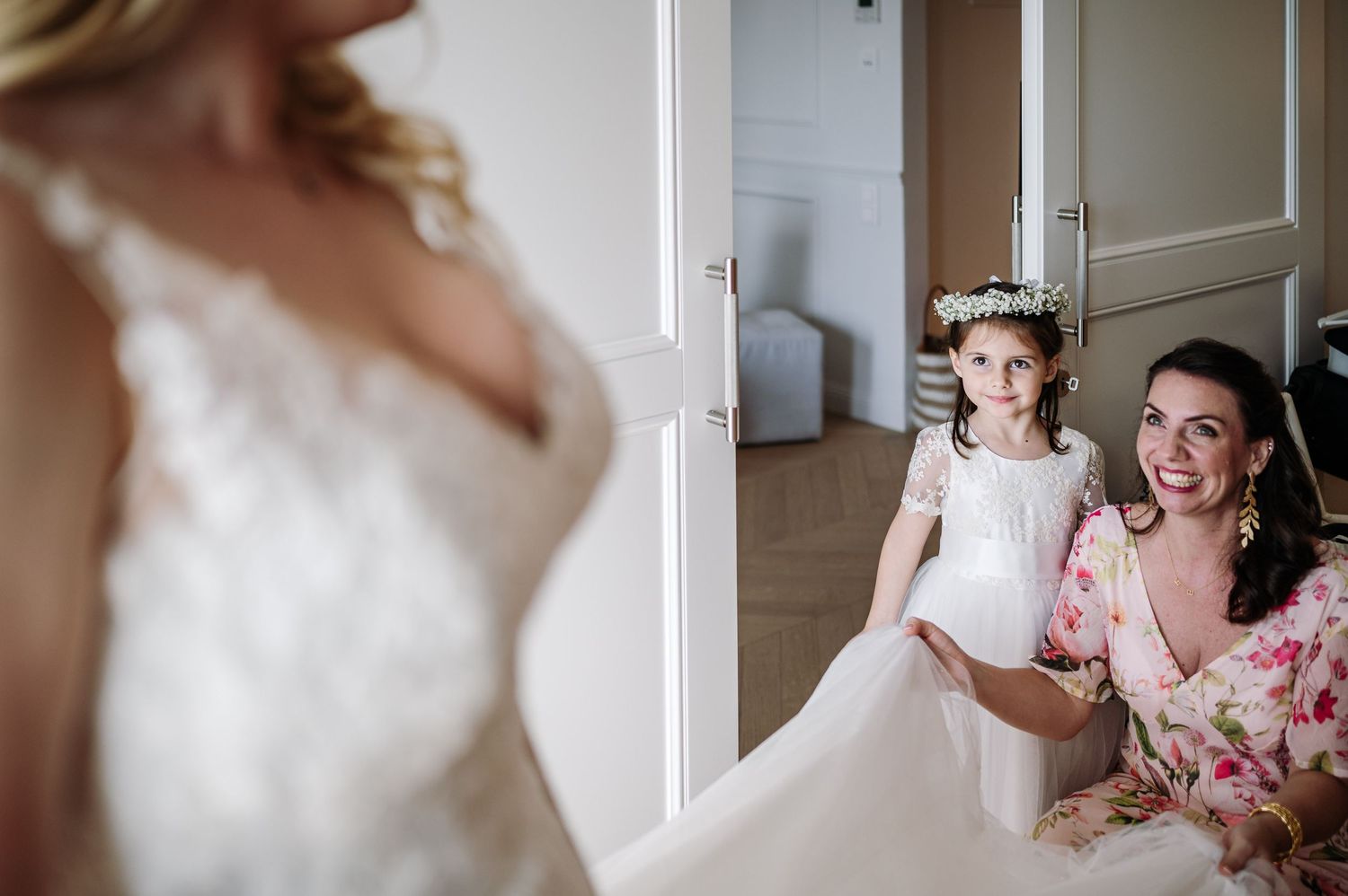 Wedding preparation scene with white doors and elegant interior decor.