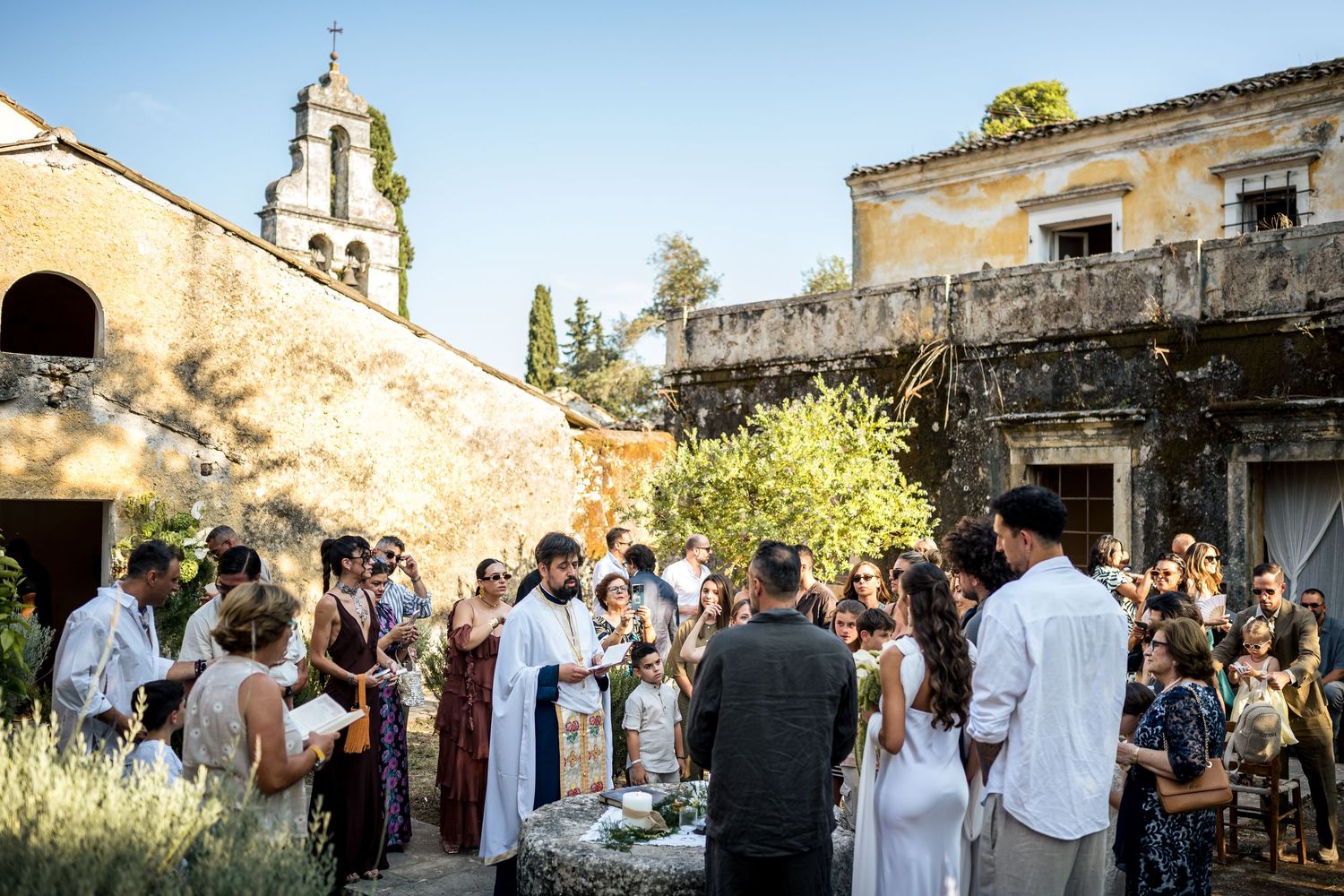 Outdoor wedding ceremony in courtyard of historic Mediterranean building.