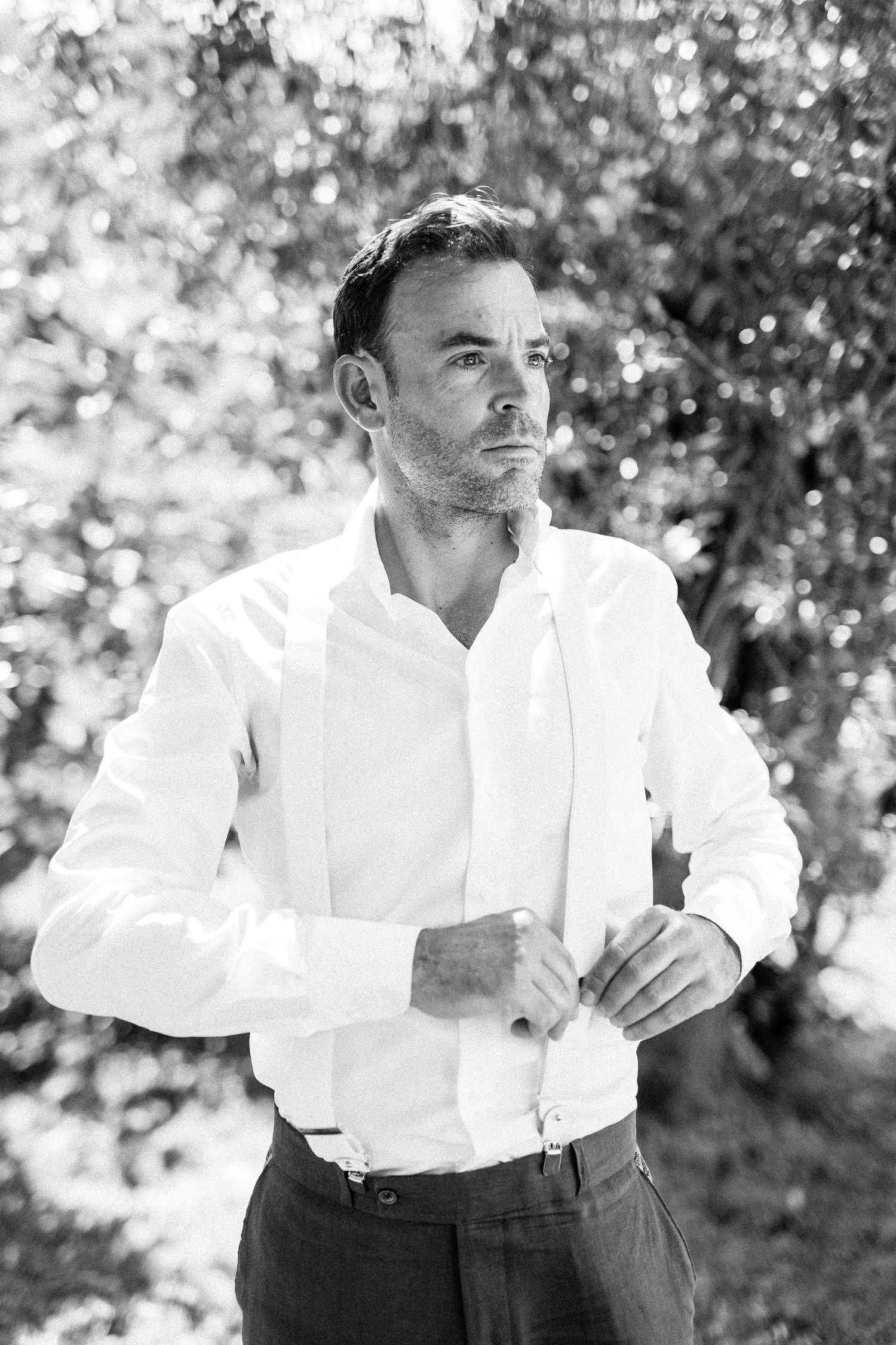 Black and white portrait series showing a man in a white shirt against a blurred outdoor background.