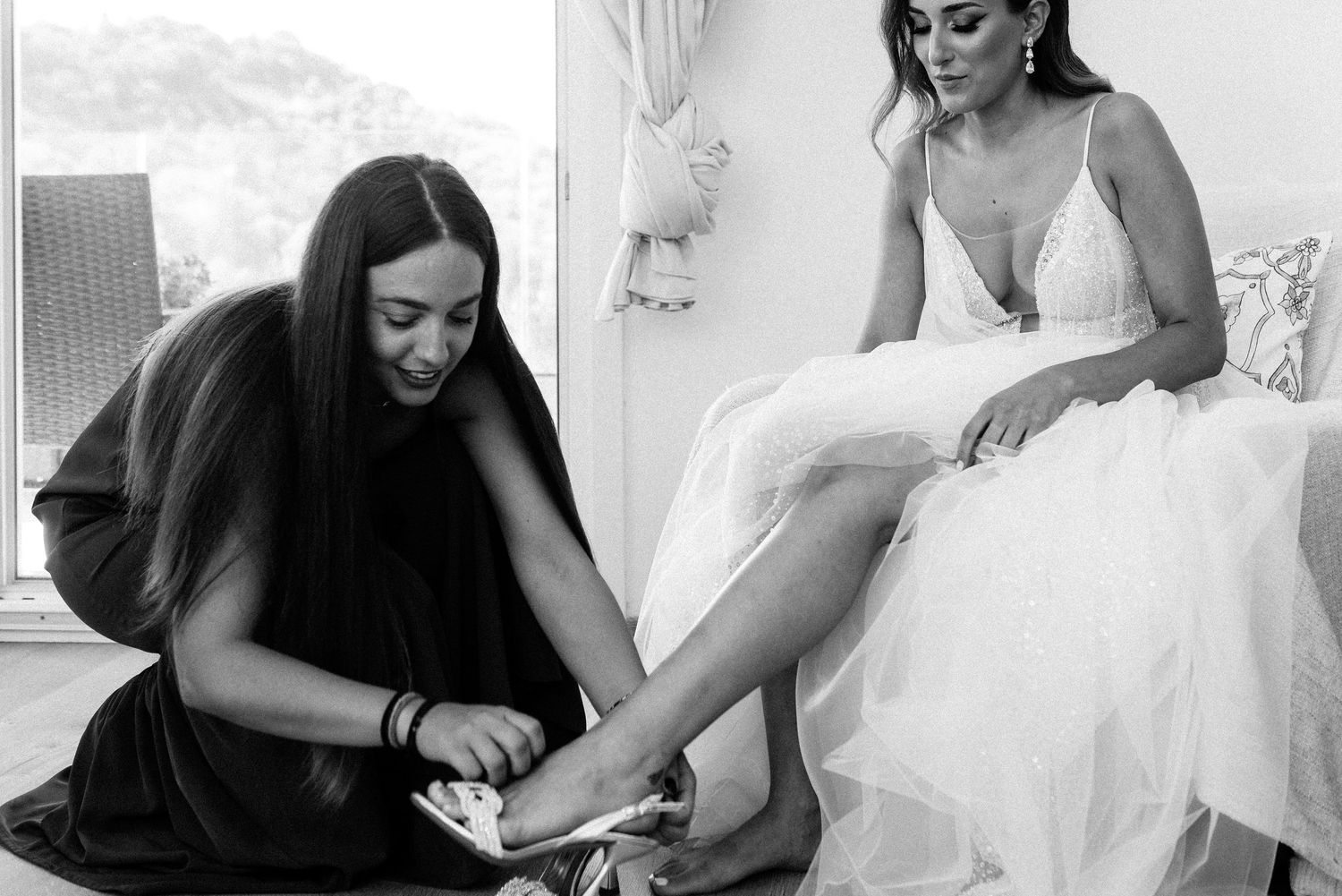 Black and white candid moments during wedding day preparations.