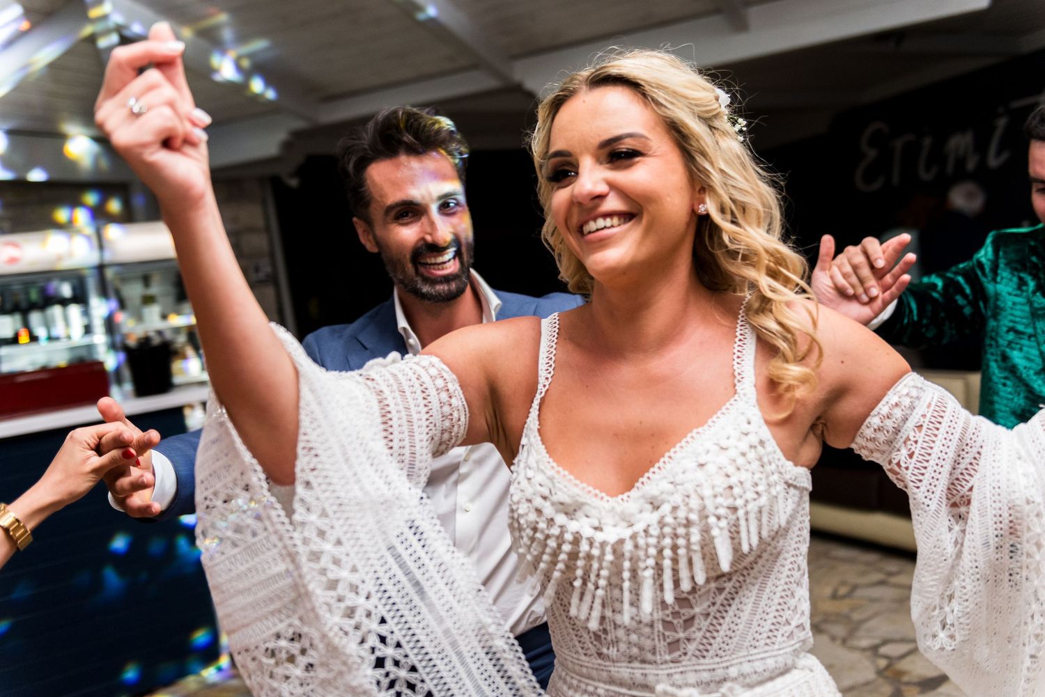 Energetic dance party scene with guests celebrating at a wedding reception.