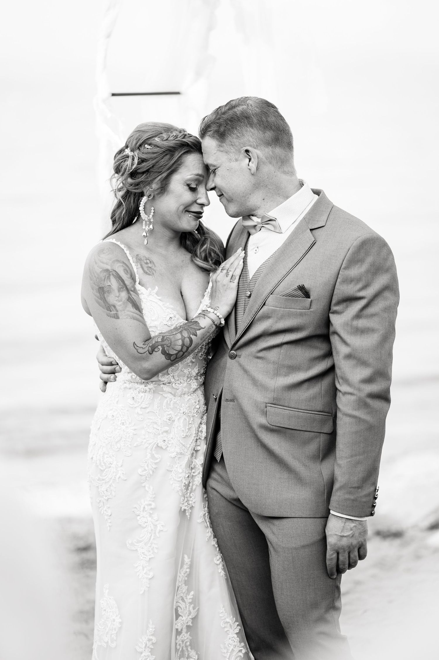 Black and white intimate wedding portraits showing tender moments between newlyweds.