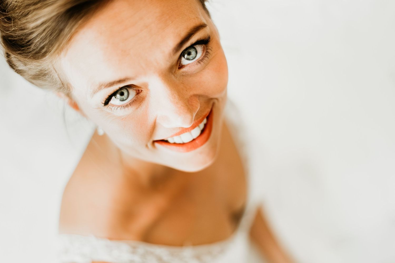 Close-up bridal portraits showing natural makeup and joyful expressions.