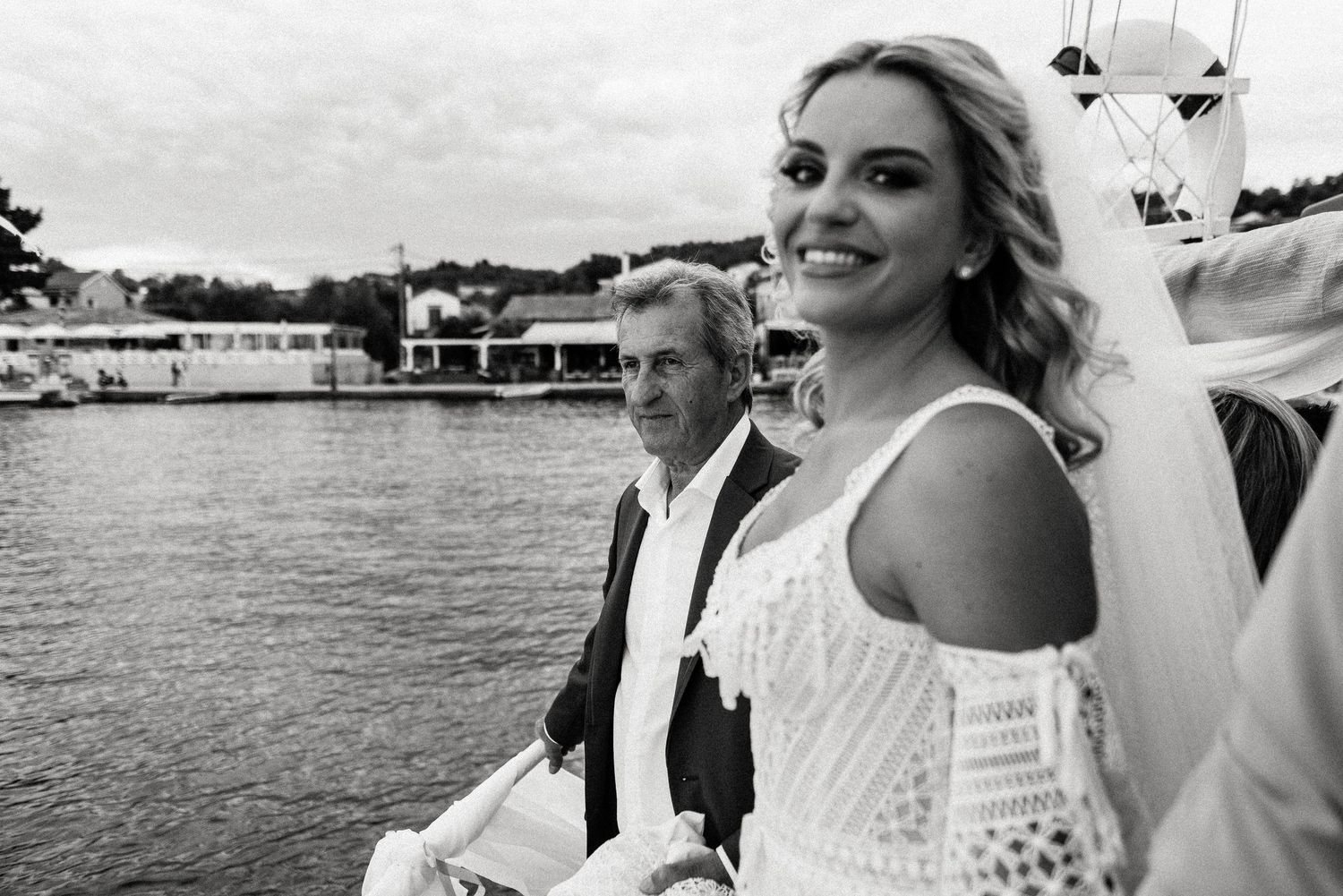 Seaside wedding celebration with boats and water views.