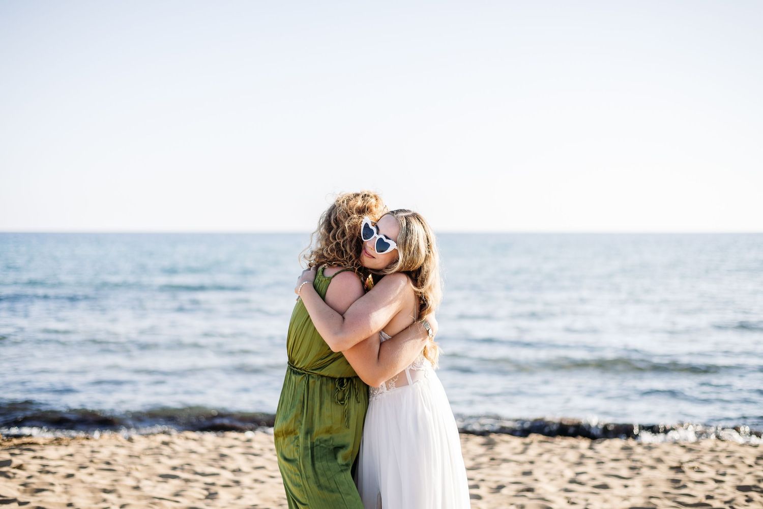 Romantic moments captured during sunset beach wedding ceremony.