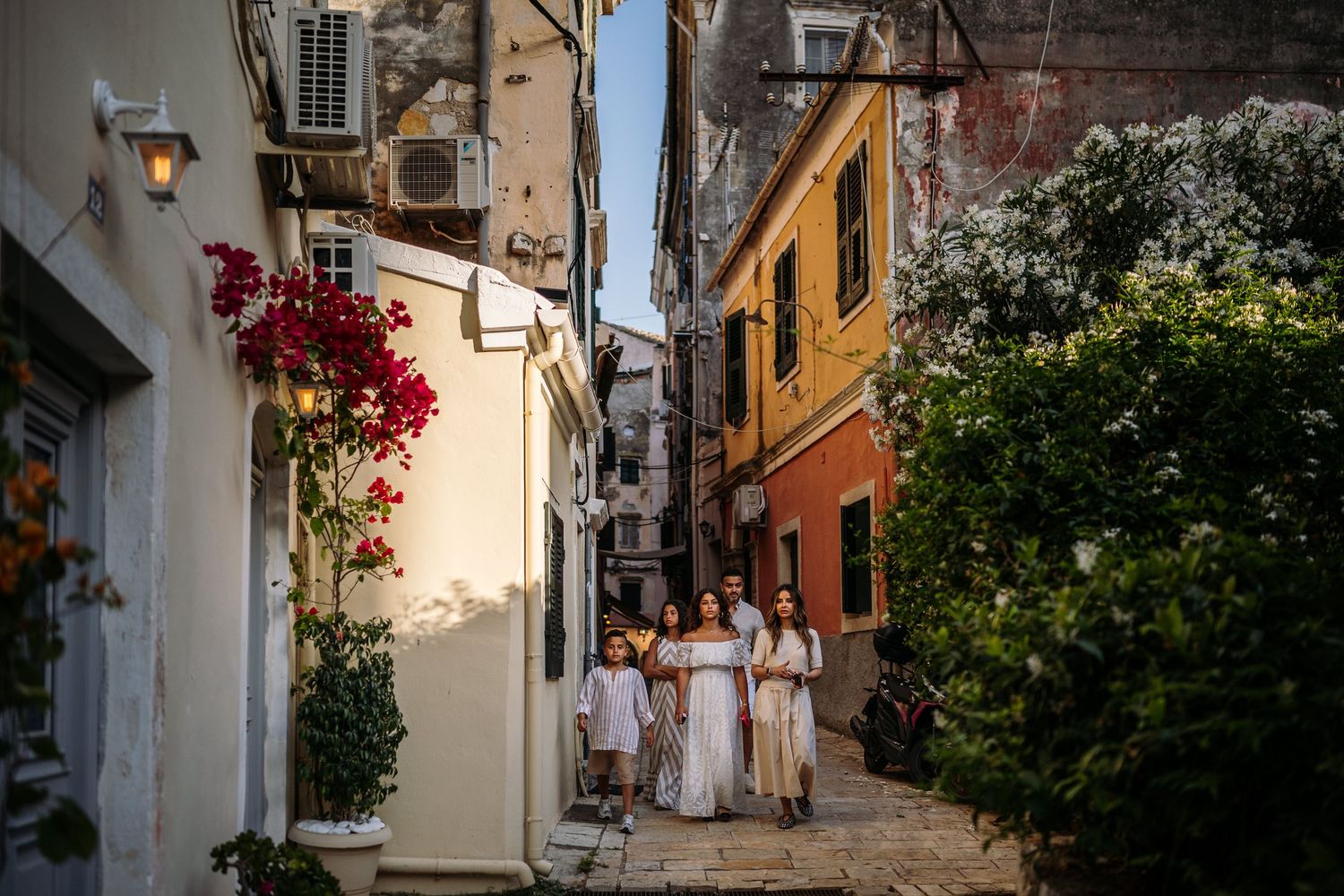 Charming Mediterranean street scene with colorful buildings and flowering vines.