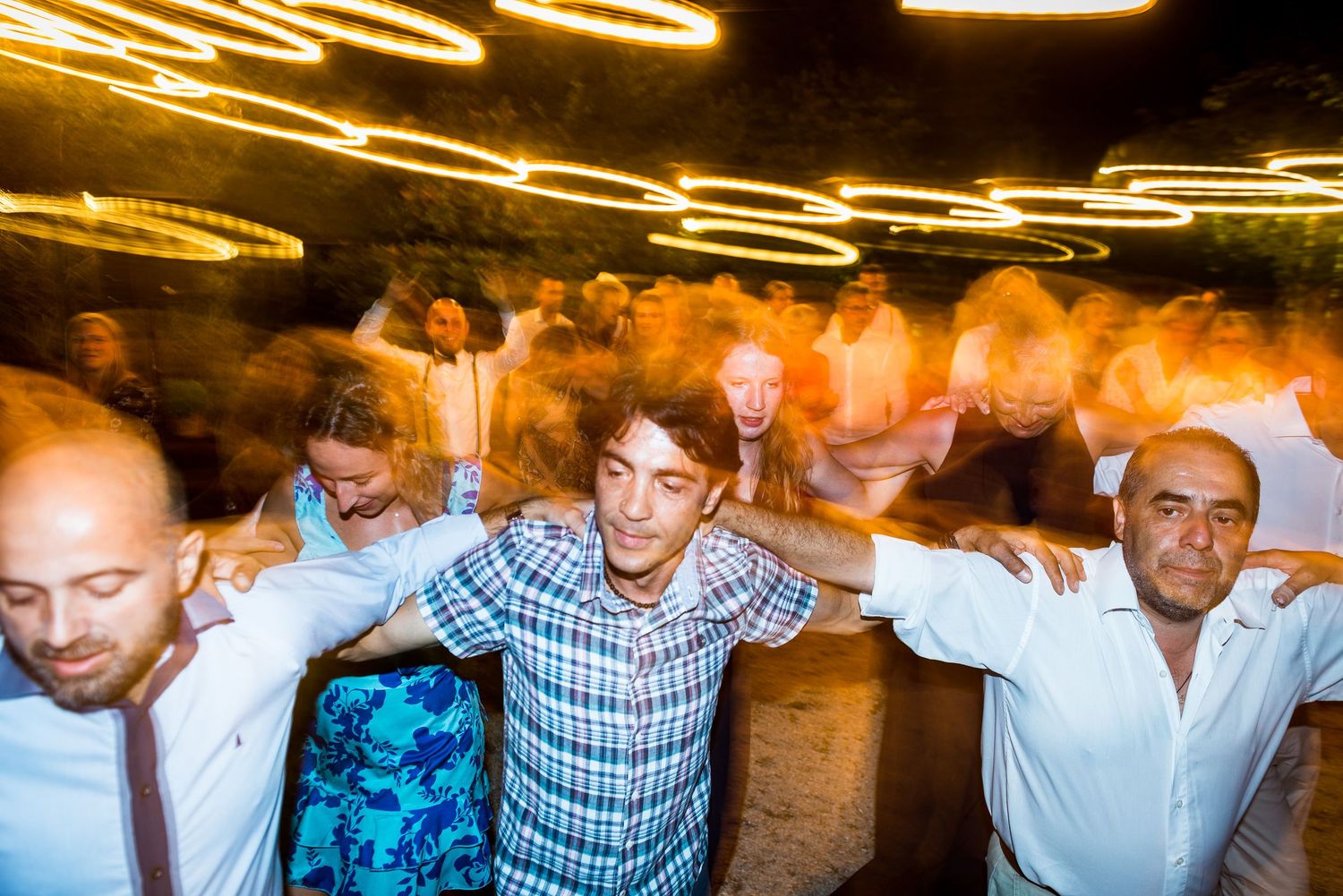 Wedding reception dance floor with string lights creating a warm atmosphere overhead.