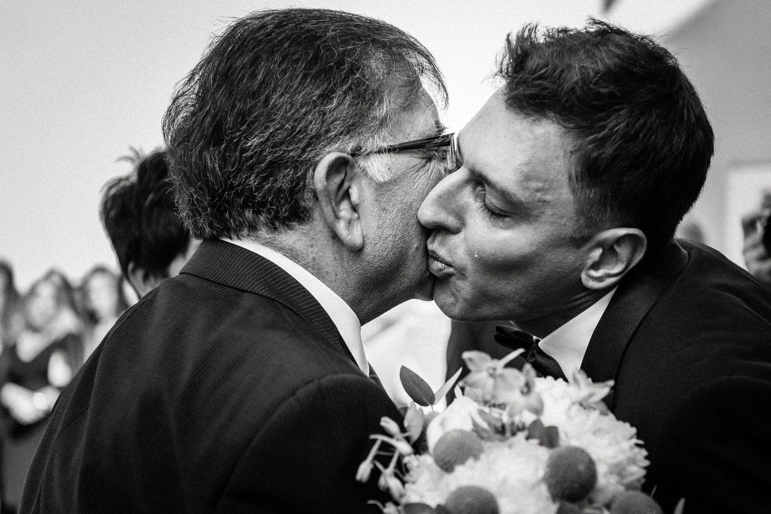 Black and white candid shots capture intimate wedding moments between guests.