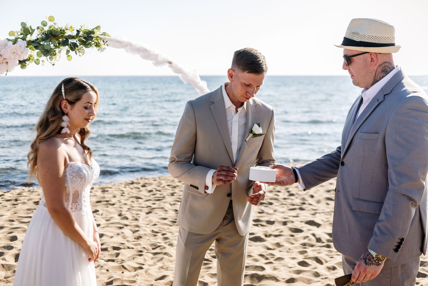 Couple sharing joyful moments during their beach wedding ceremony.