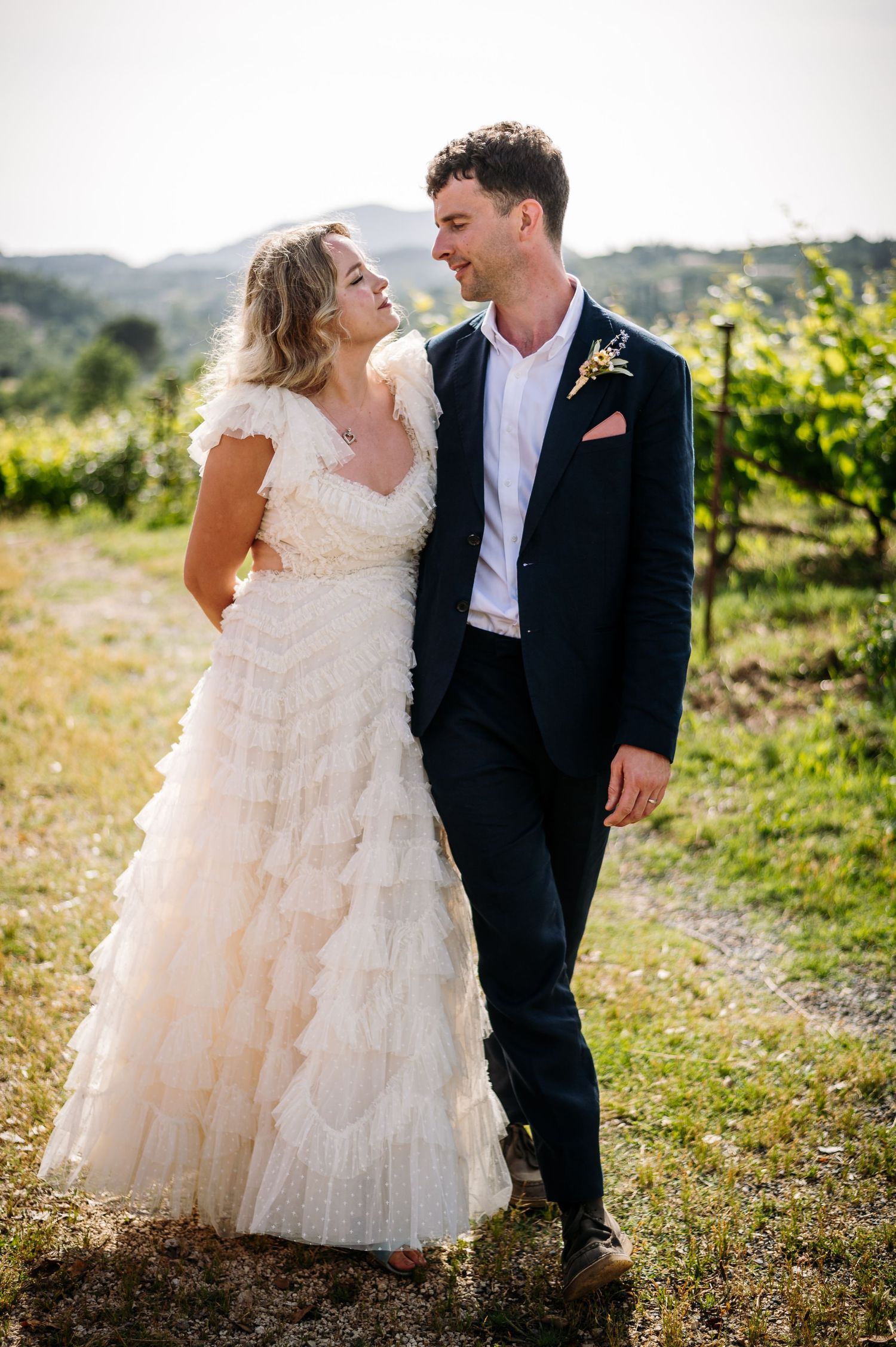 Intimate couple portraits among sun-drenched vineyard rows.