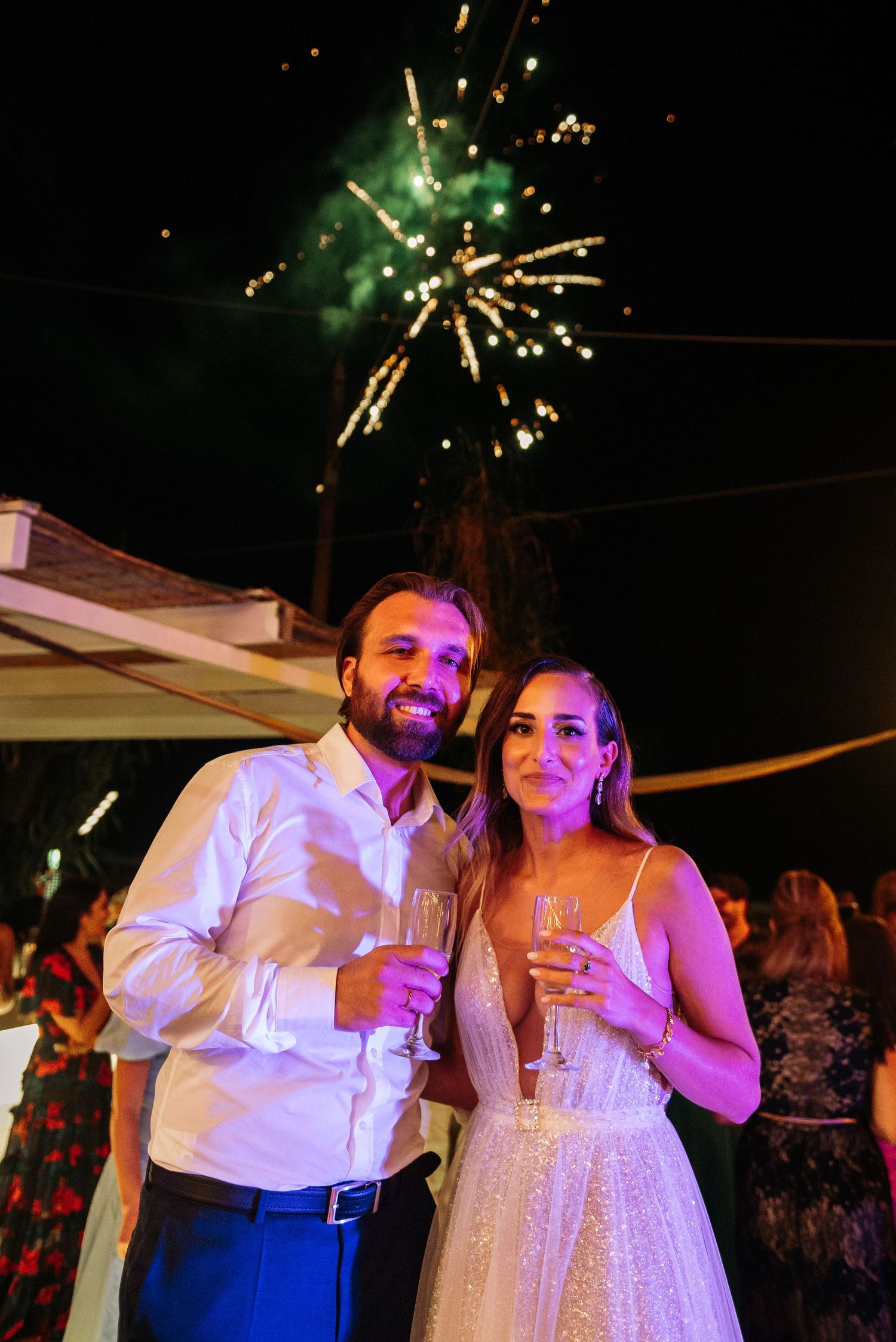 Fireworks light up the night sky during wedding celebration.