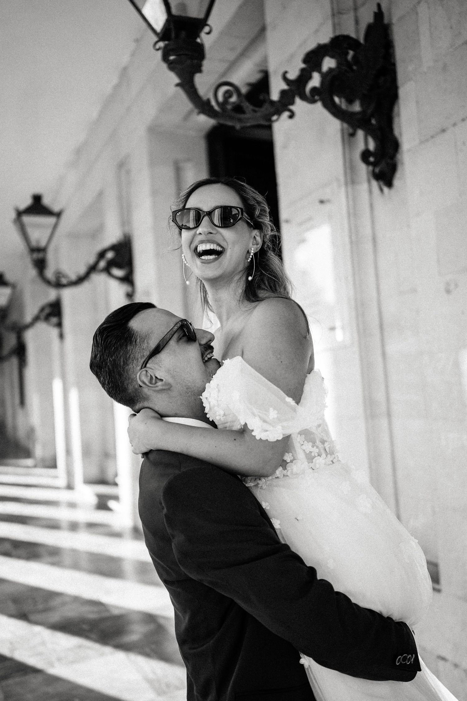 Black and white photos capture joyful dancing moments between newlyweds in a bright hallway.