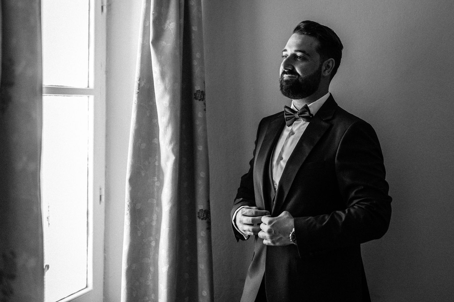 Black and white photos of formal-dressed men by window light.