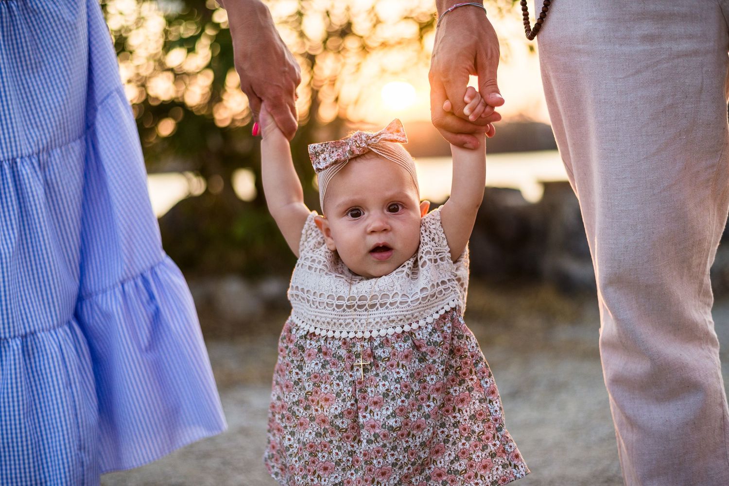 Family members walking together at sunset wearing coordinated blue and floral outfits.