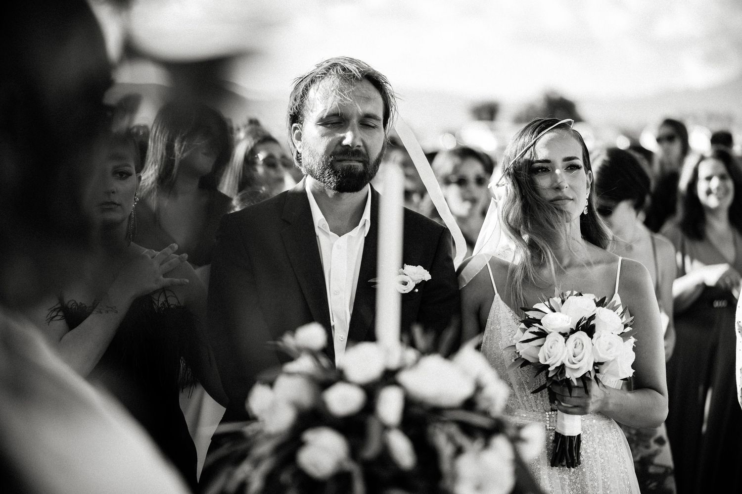 Black and white candid shots capturing joyful reactions during wedding celebrations.