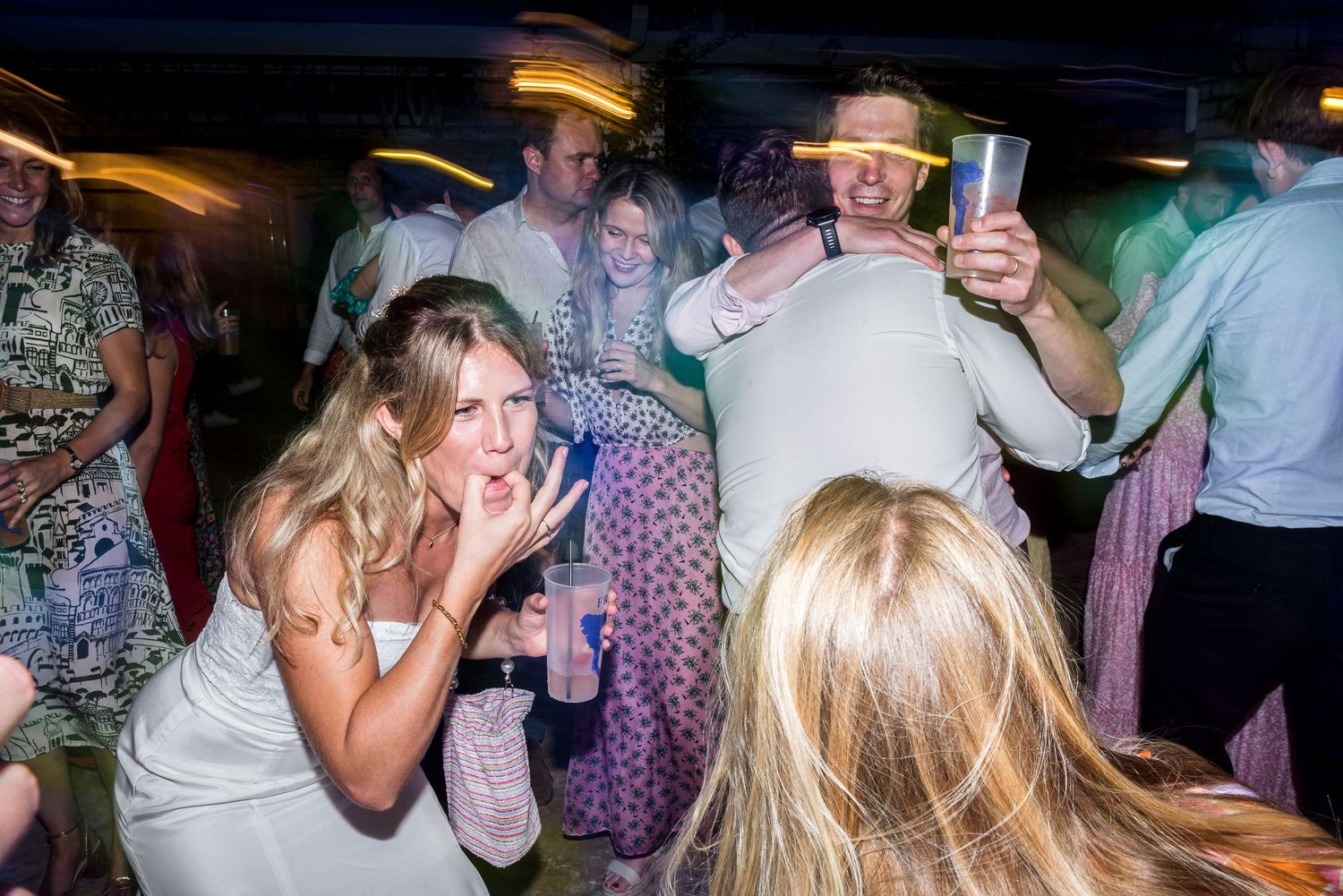 Candid shots of party guests celebrating and dancing at a nighttime social event.