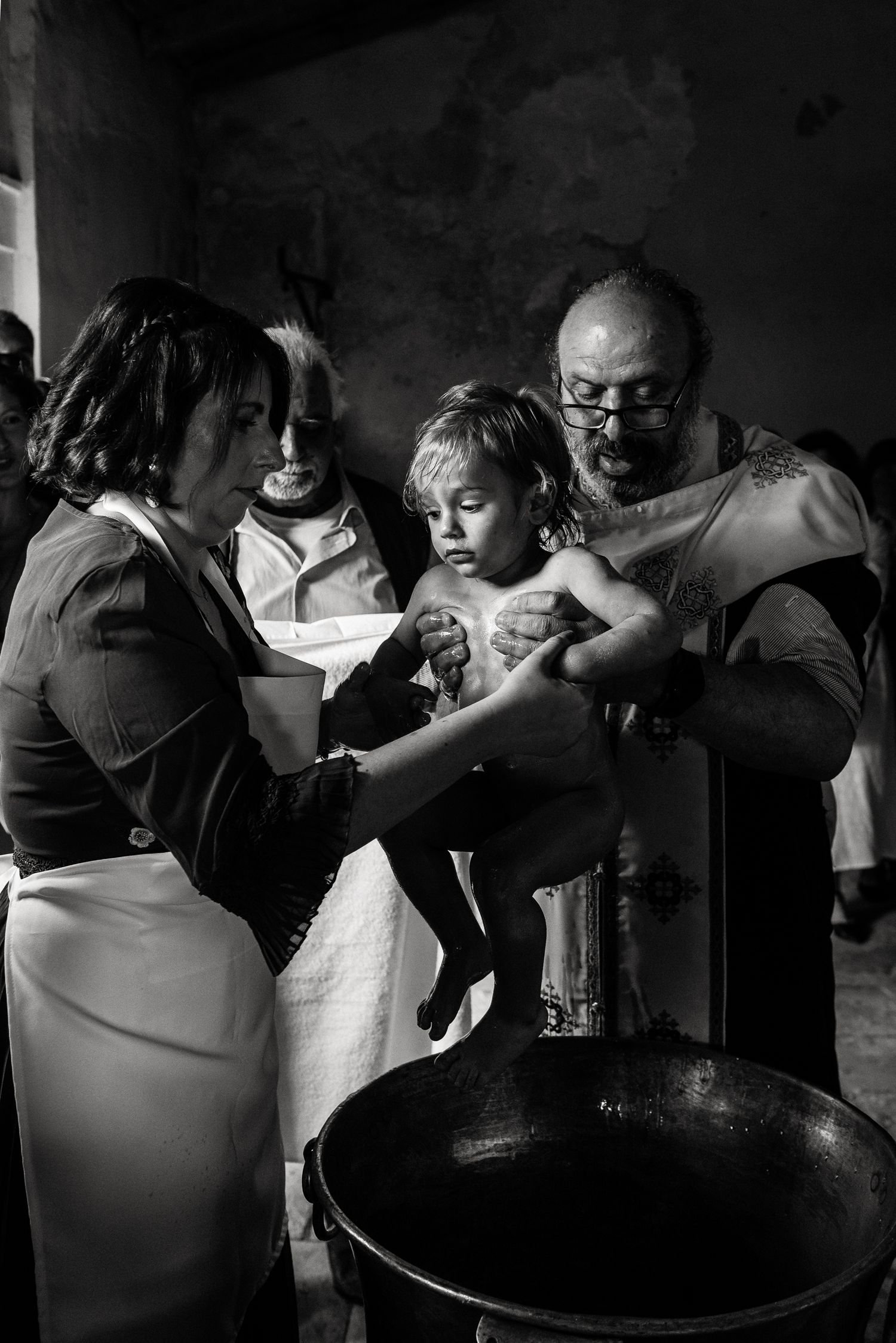 Dramatic black and white sequence capturing emotional embraces during a celebration.