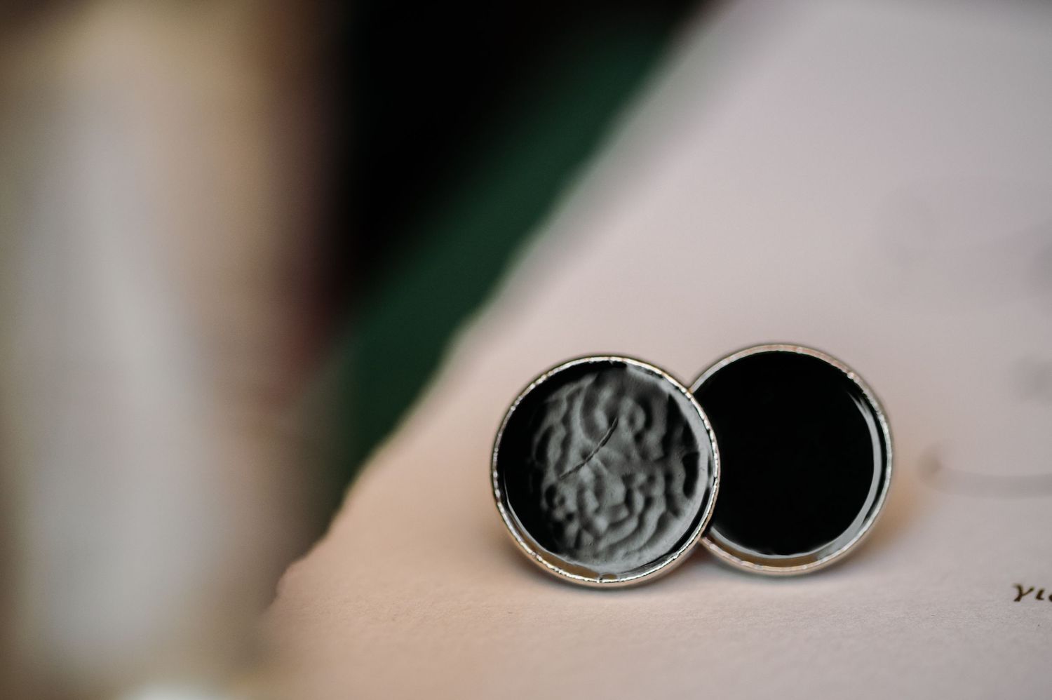 Close-up detail shot of wedding rings with artistic bokeh background.
