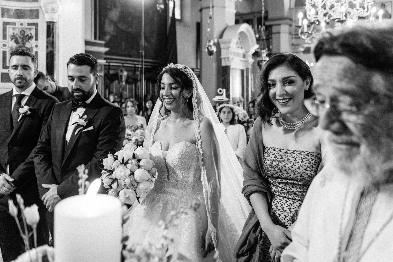 Black and white candid shots of wedding guests enjoying the celebration.