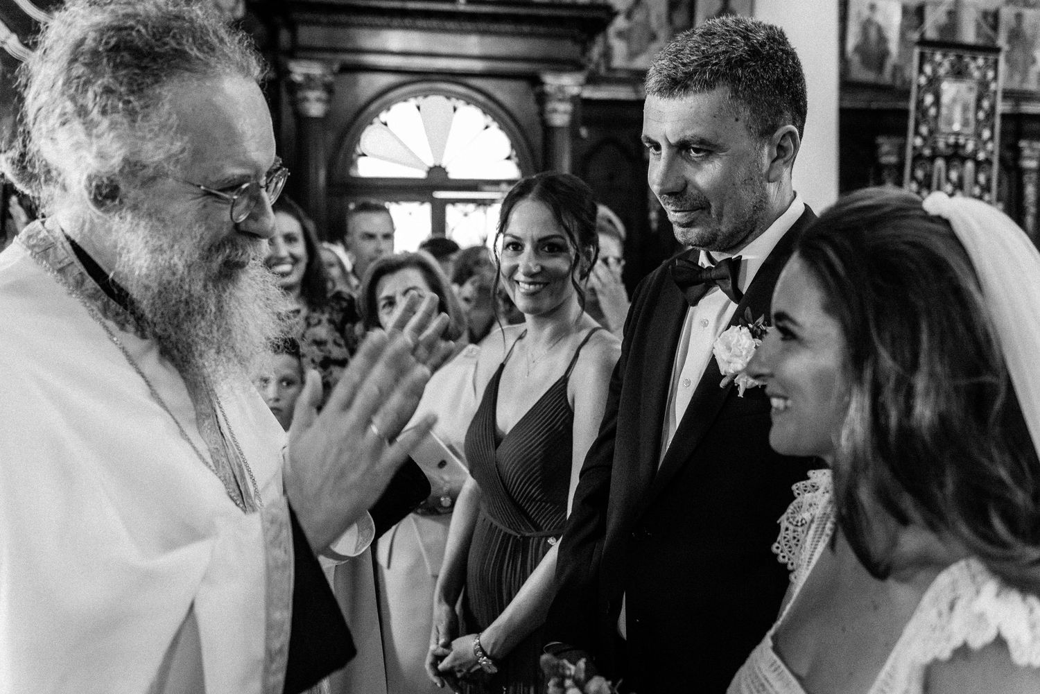 Candid black and white shots of wedding guests sharing emotional moments during the celebration.