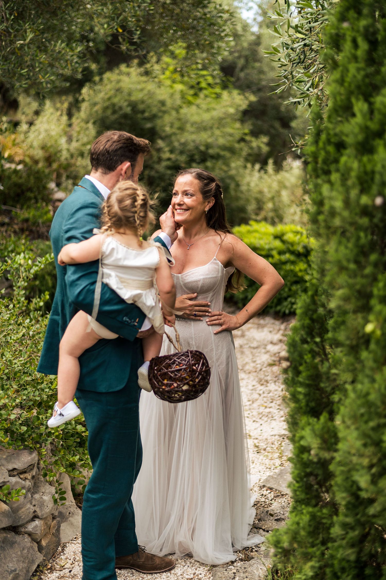 Candid wedding moments captured in a garden setting with lush greenery.