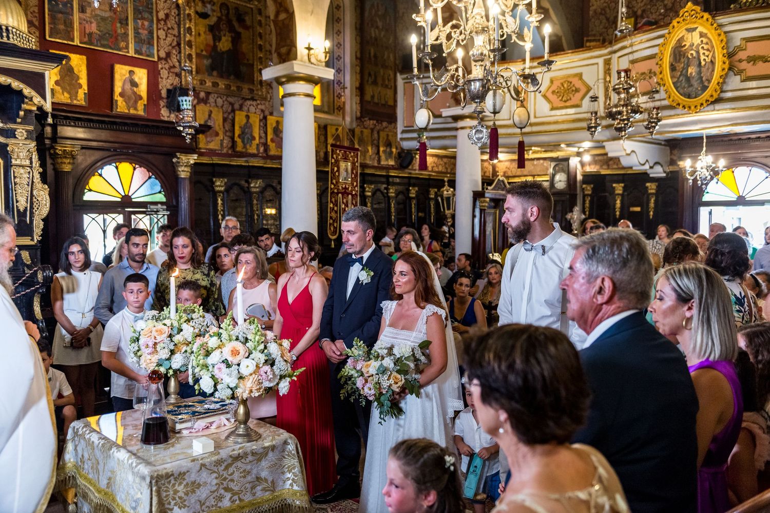 Ornate church interior decorated with elegant floral arrangements for a wedding ceremony.