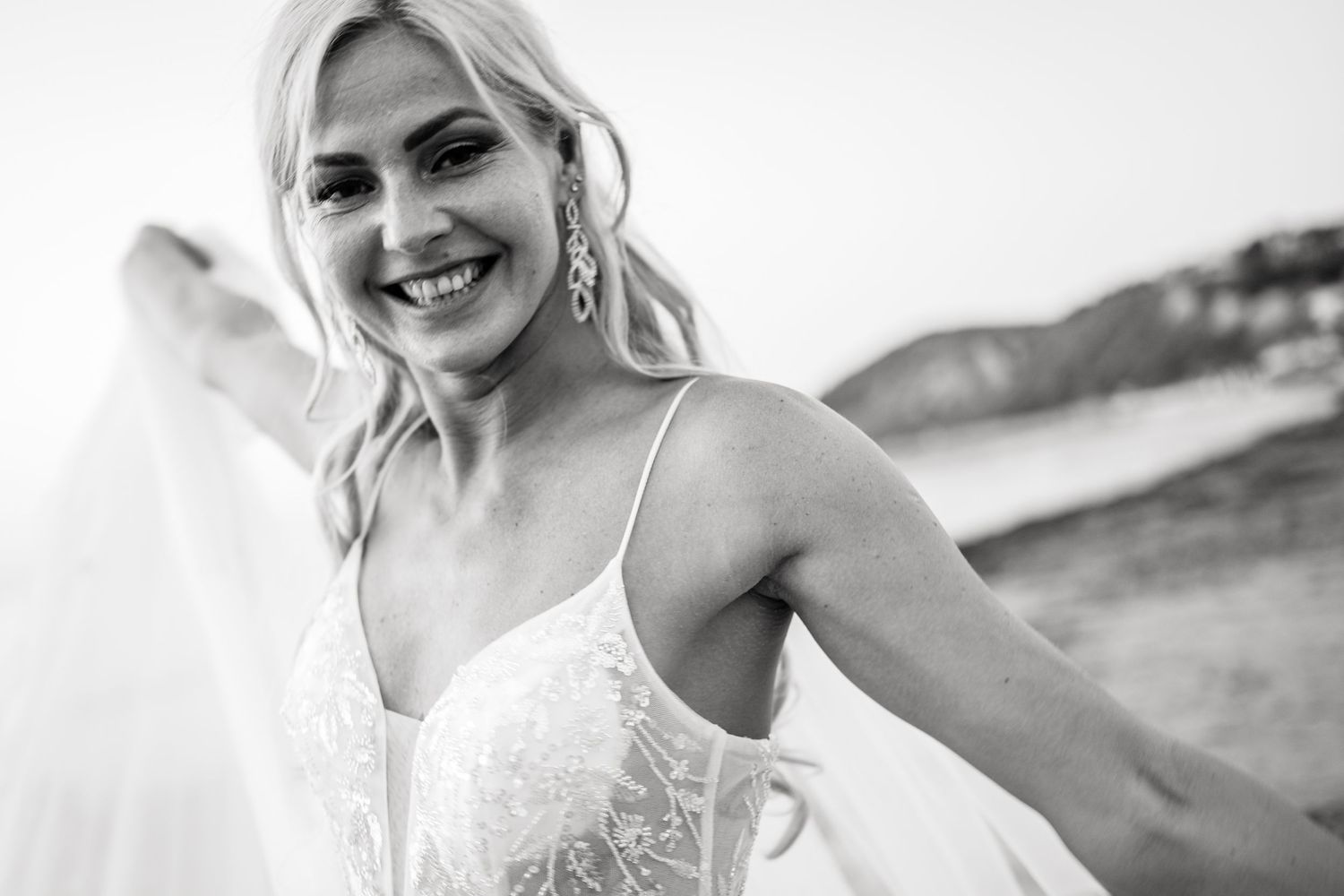 Candid smiles and laughter during a beachside photo session.