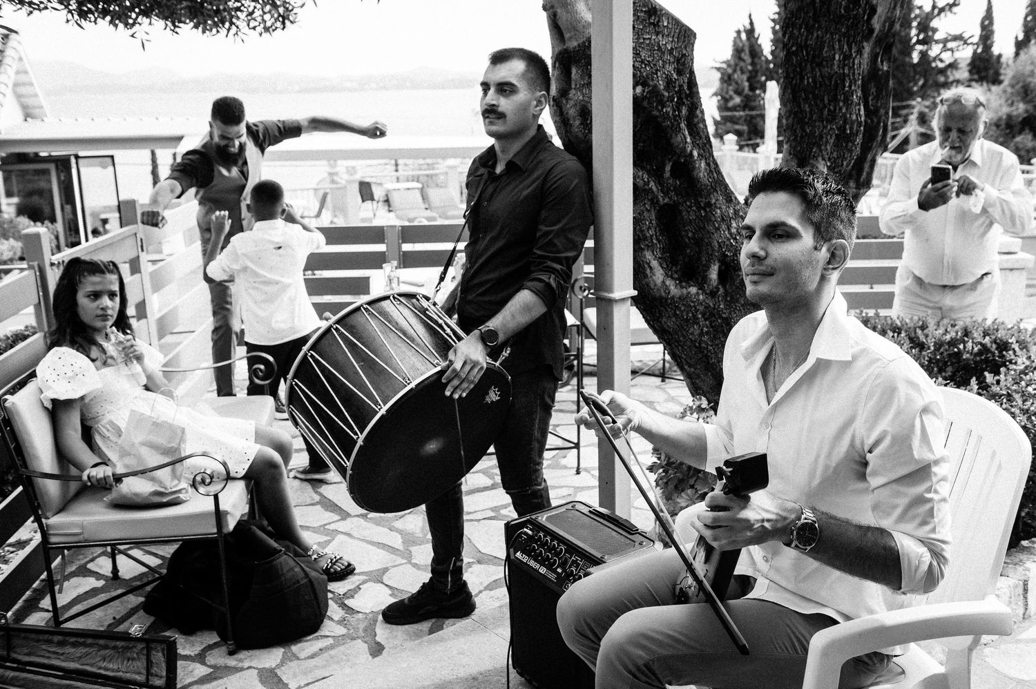 Musicians perform at an outdoor wedding celebration.