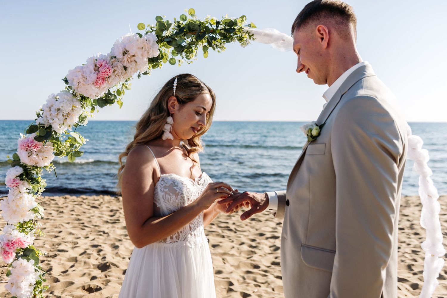 Beautiful beach wedding ceremony with floral decor and ocean views.