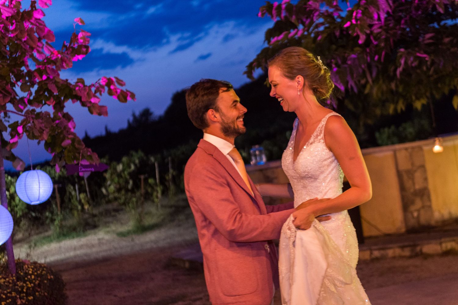 A romantic evening dance scene with purple flowers and blue sky in the background.