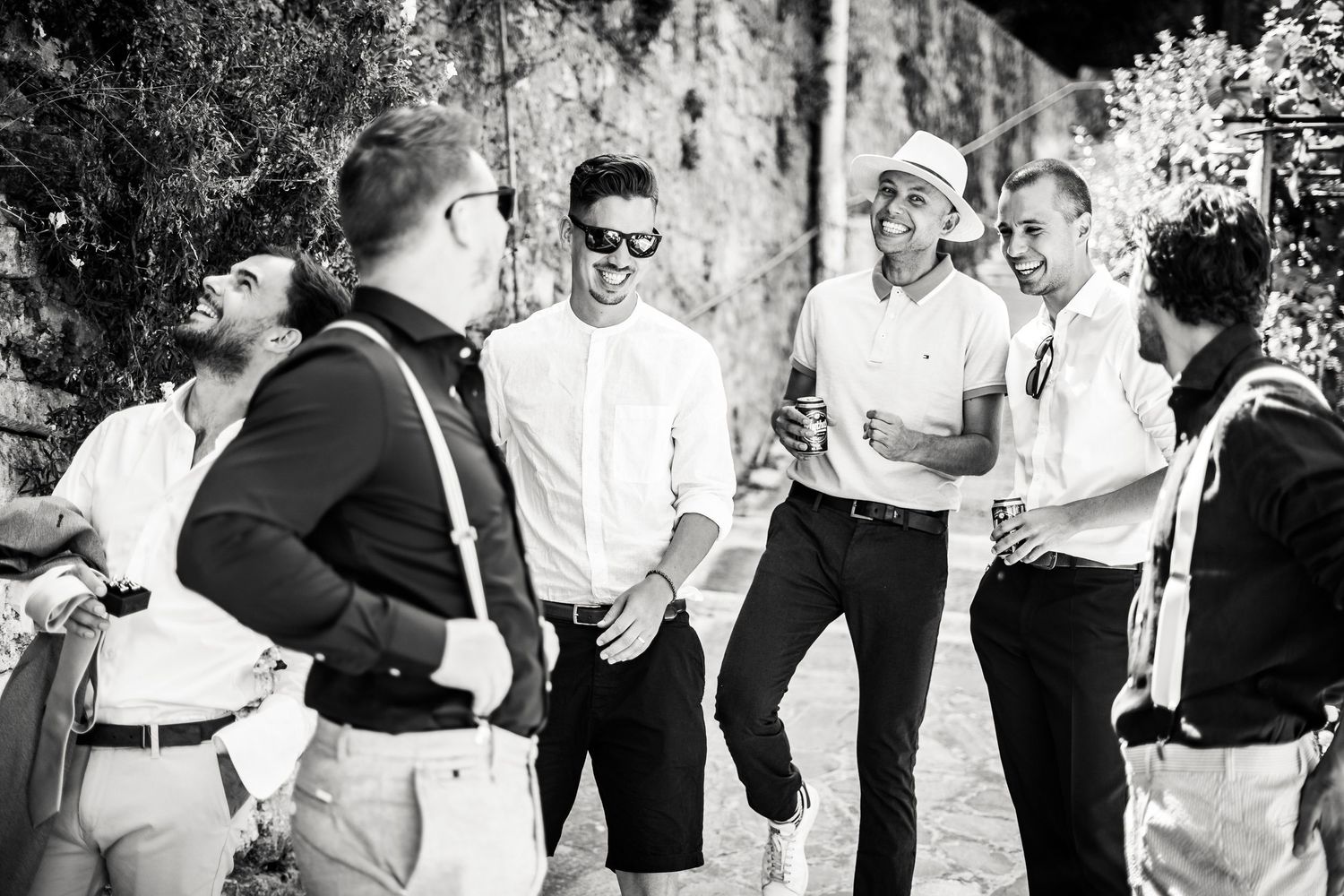 Black and white images of joyful dancing at outdoor wedding party.
