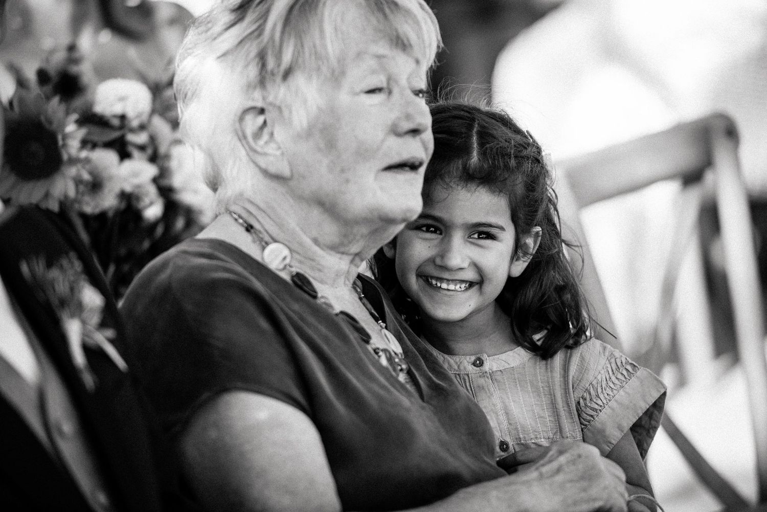 Candid black and white photos showing joyful reactions during wedding ceremony.