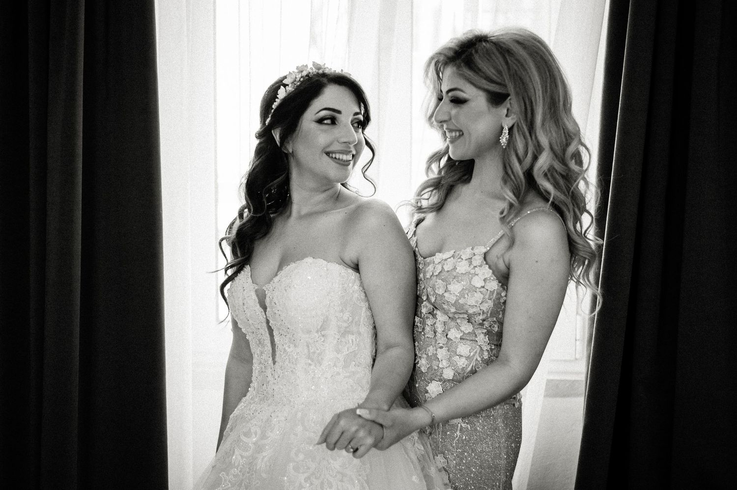 Black and white portraits showing tender moments during wedding preparations.