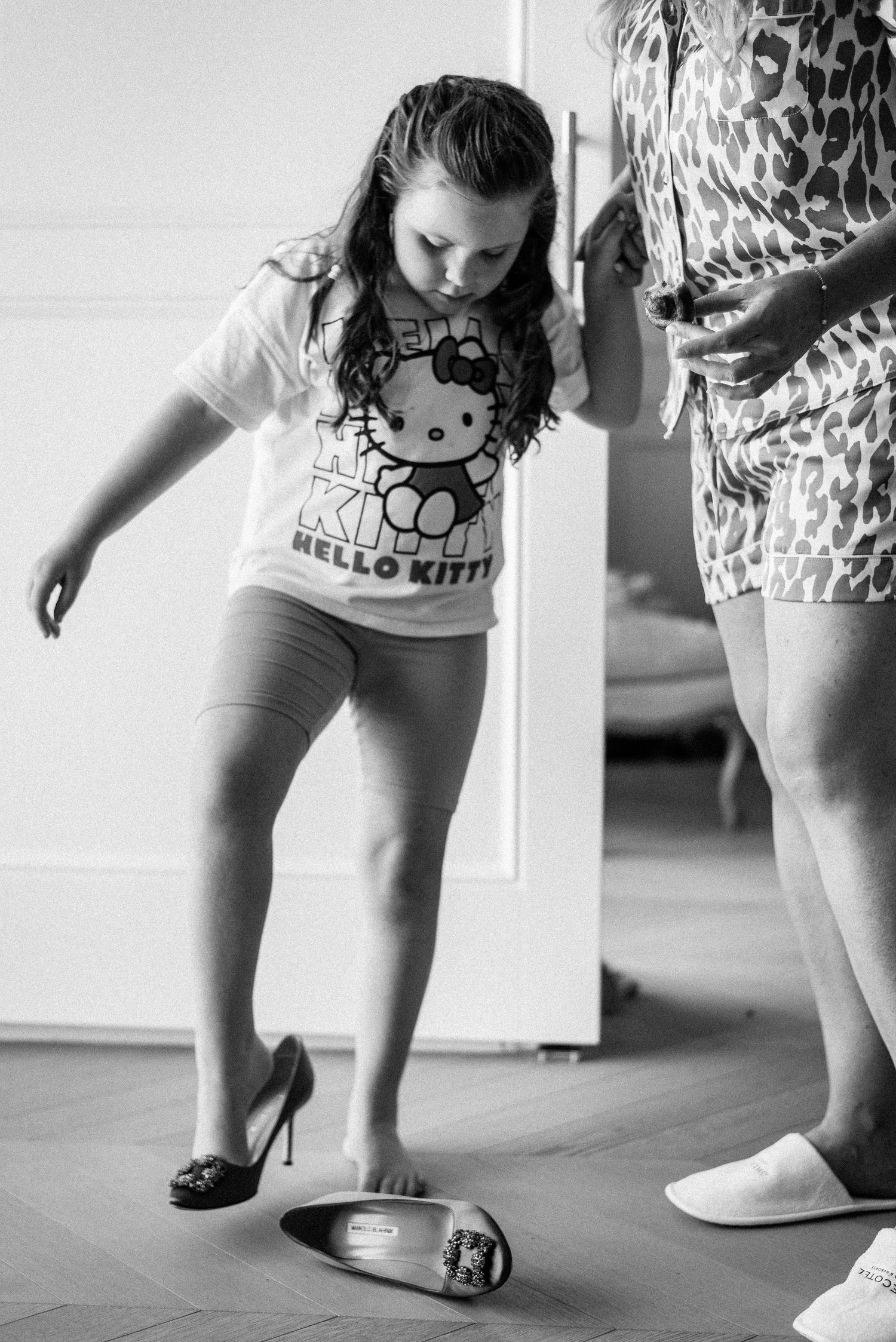 Black and white detail shots of feet and legs with Hello Kitty design clothing.