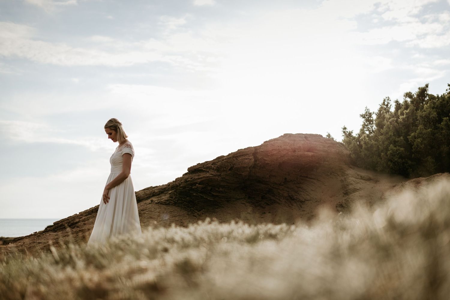 Ethereal bridal portraits in misty mountain landscape at golden hour.