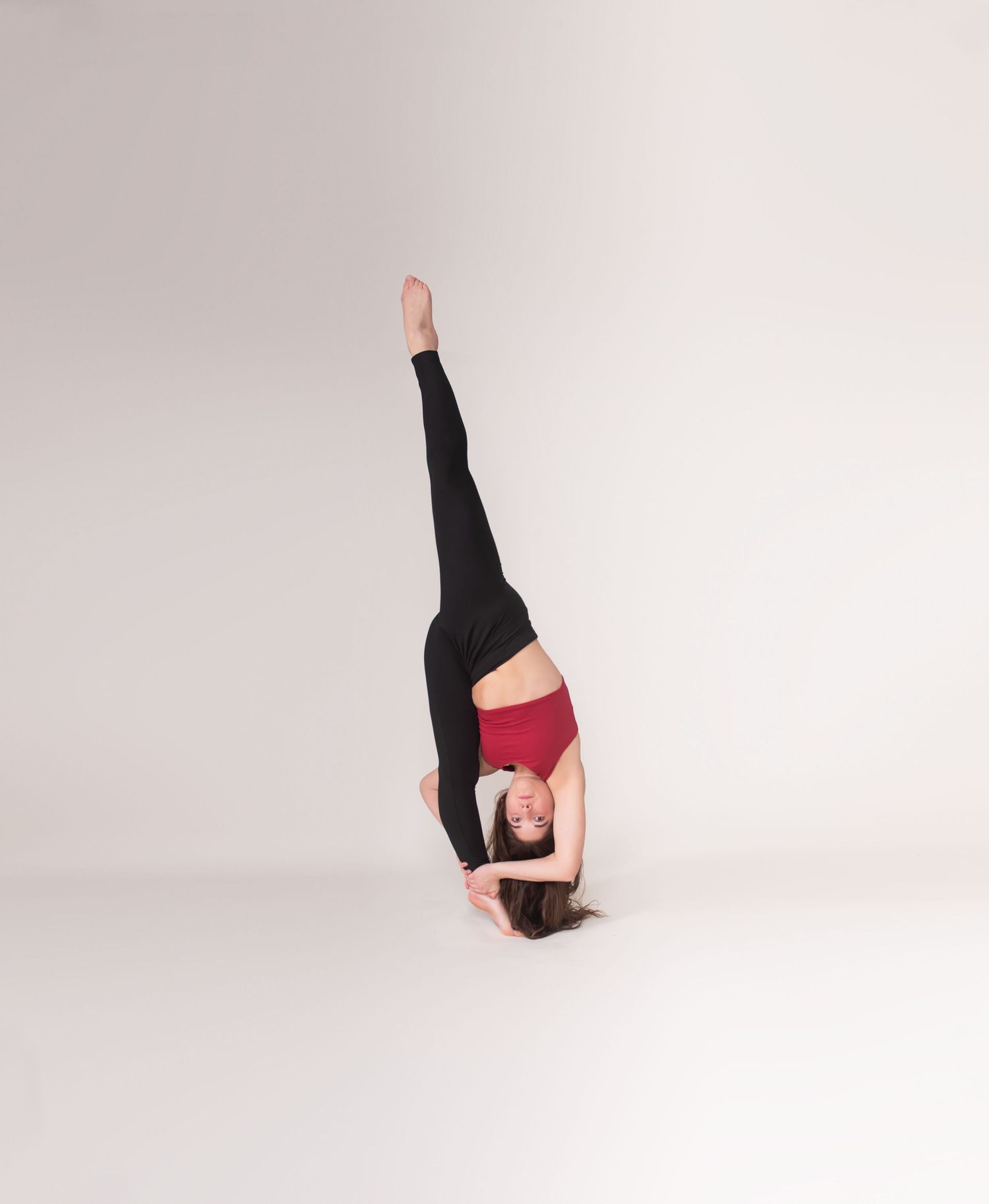 Athletic figure performs dynamic dance poses in black attire against white background.