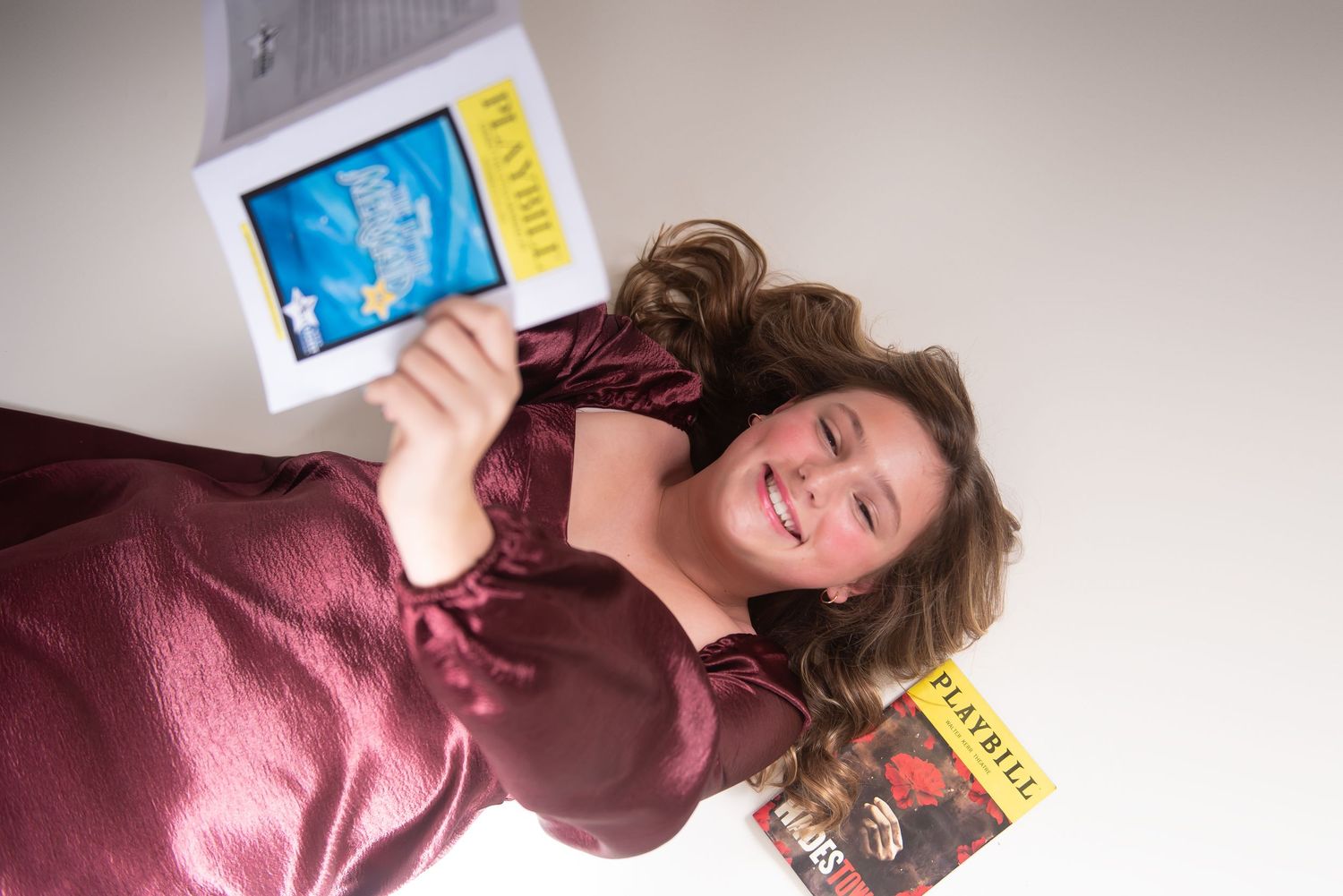 Creative photo composition with person holding tablet displaying vibrant blue imagery.