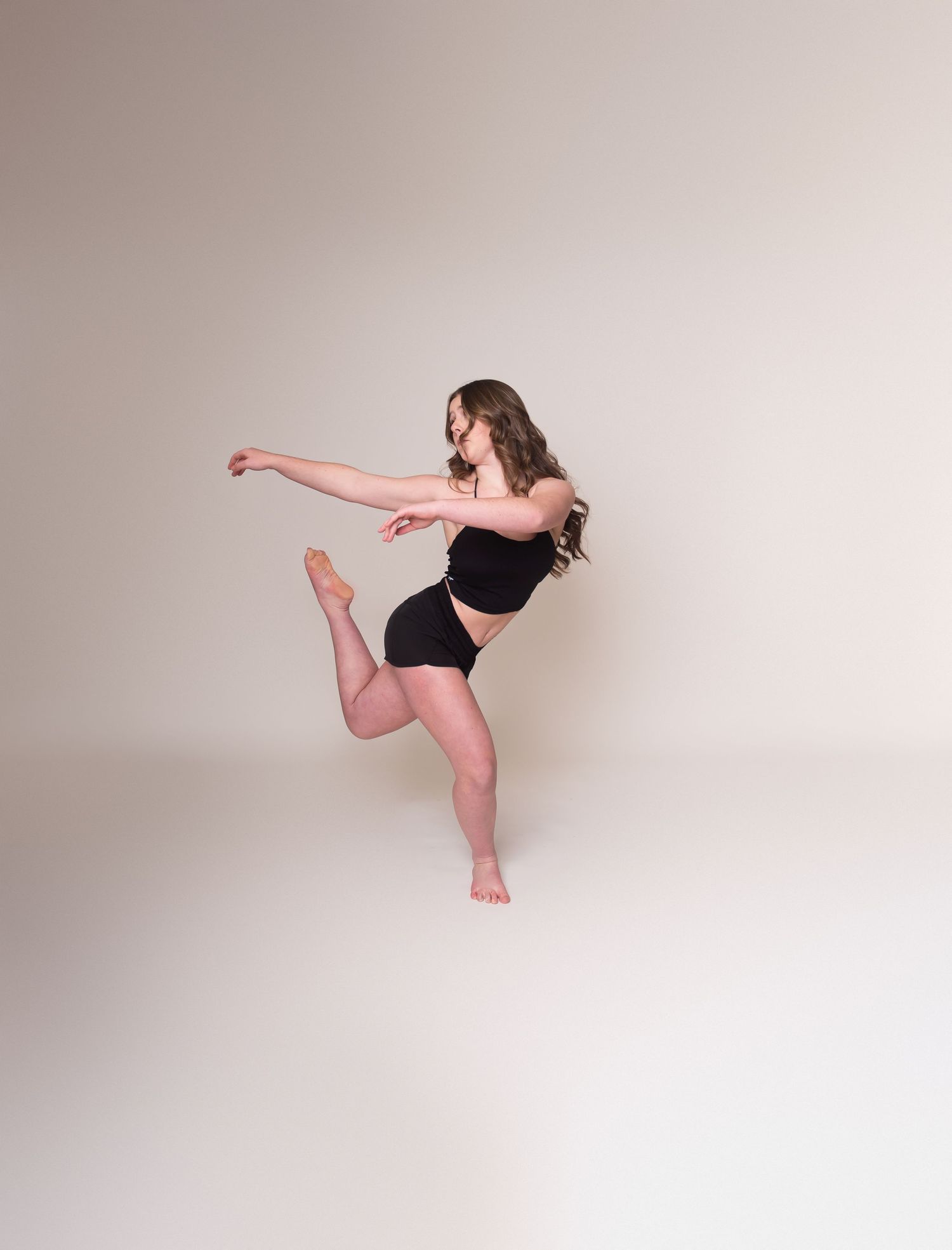 Athletic dance sequence showing controlled kicks and poses in studio setting.